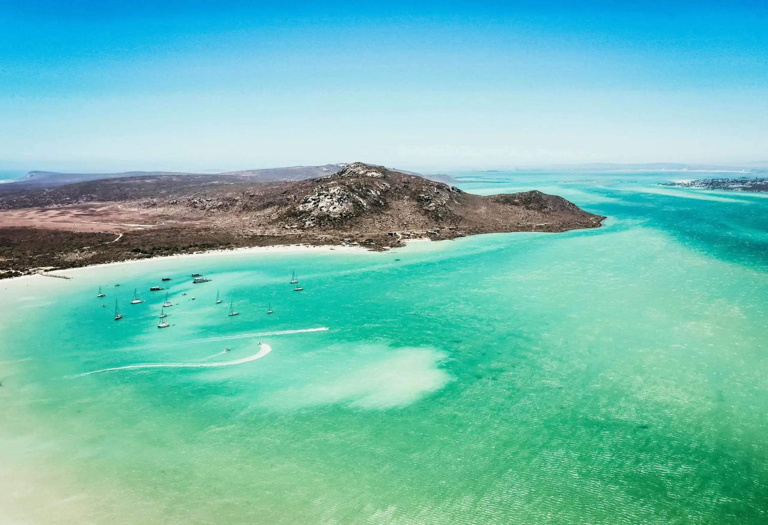 Aerial view of a lagoon with turquoise wtaer and sailing boats in a bay