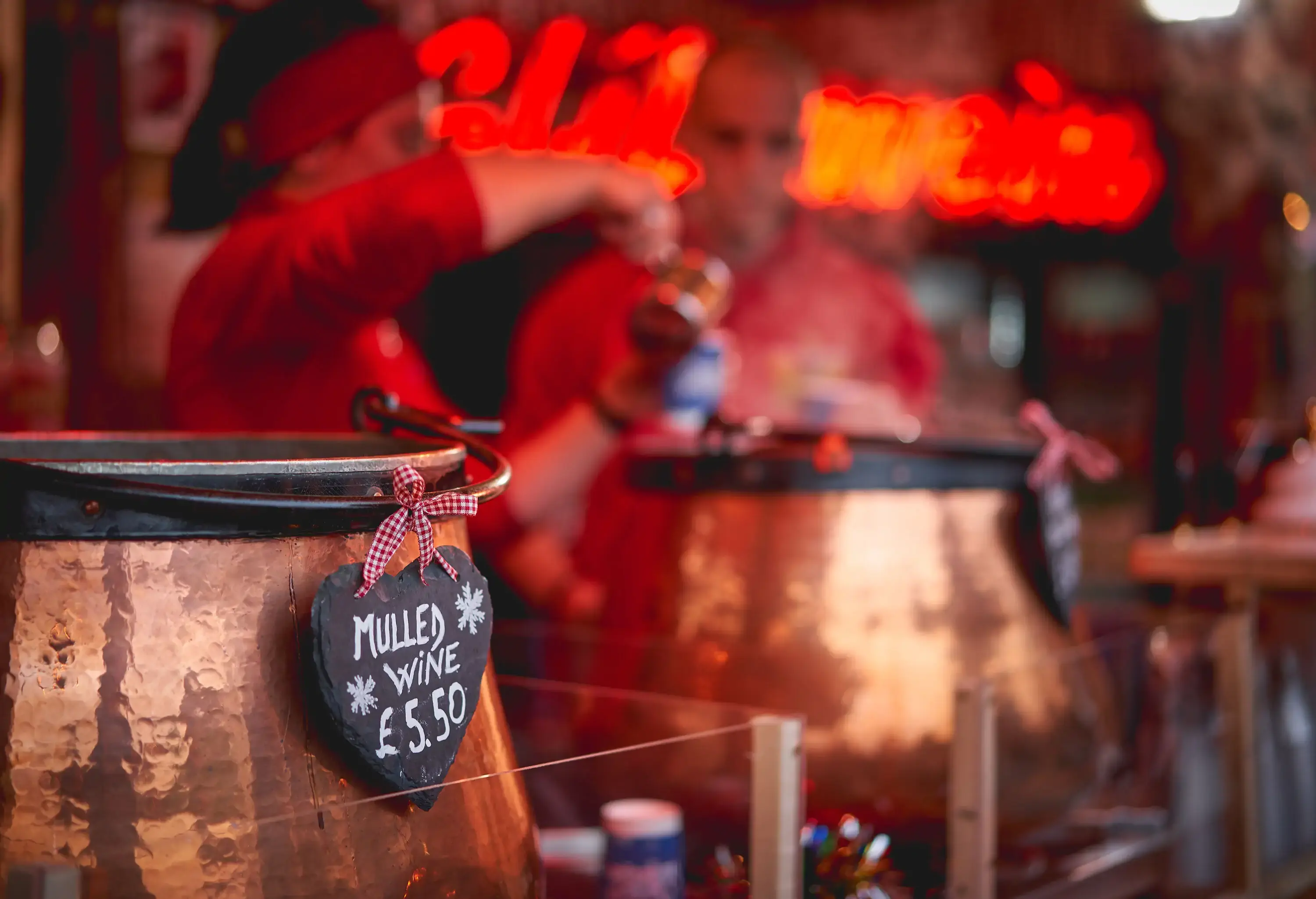 Pots of mulled wine in a stall in a Christmas market. Seasonal concept. Selective focus. Landscape format.