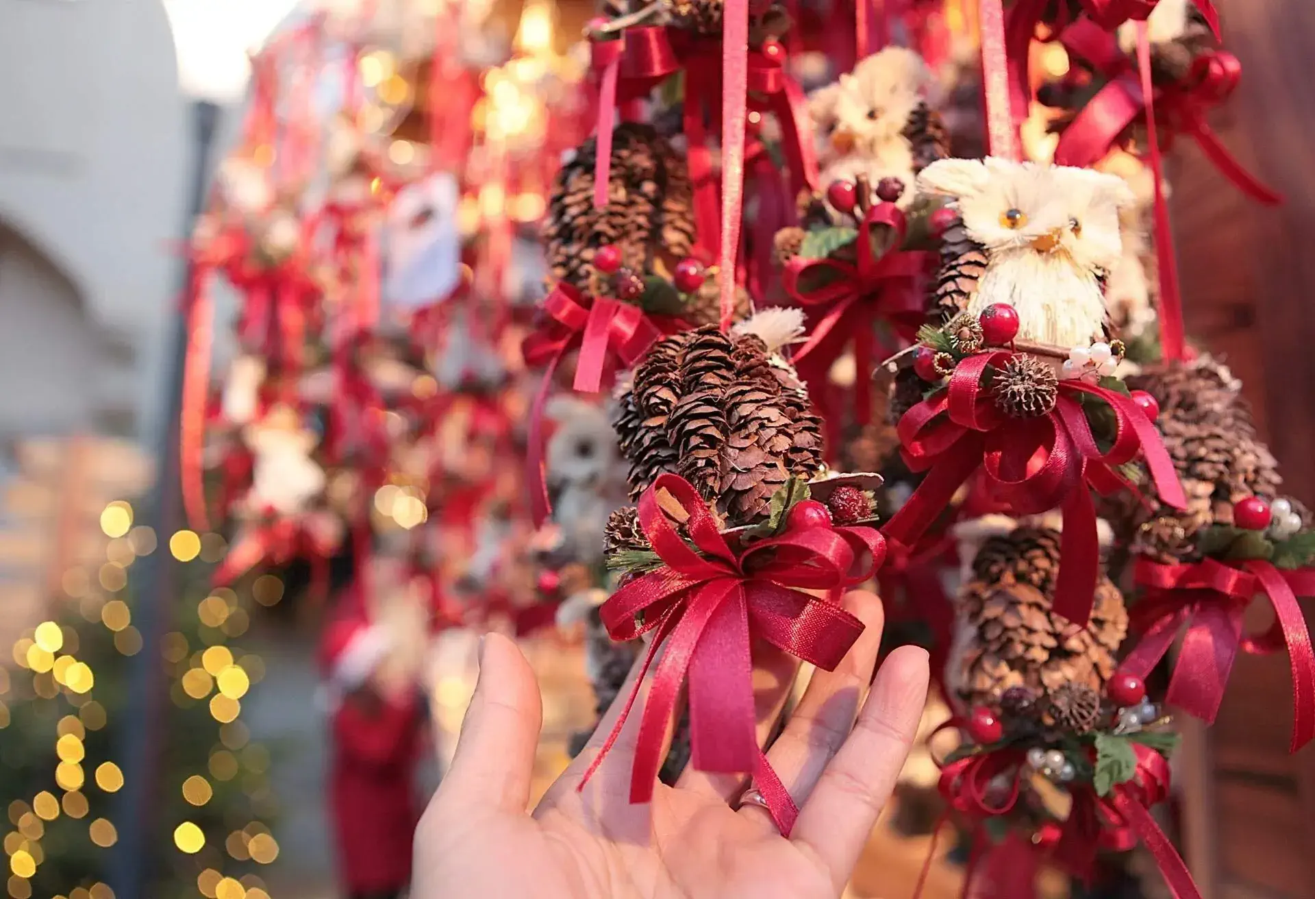 Hand touching winter decorations at Christmas market