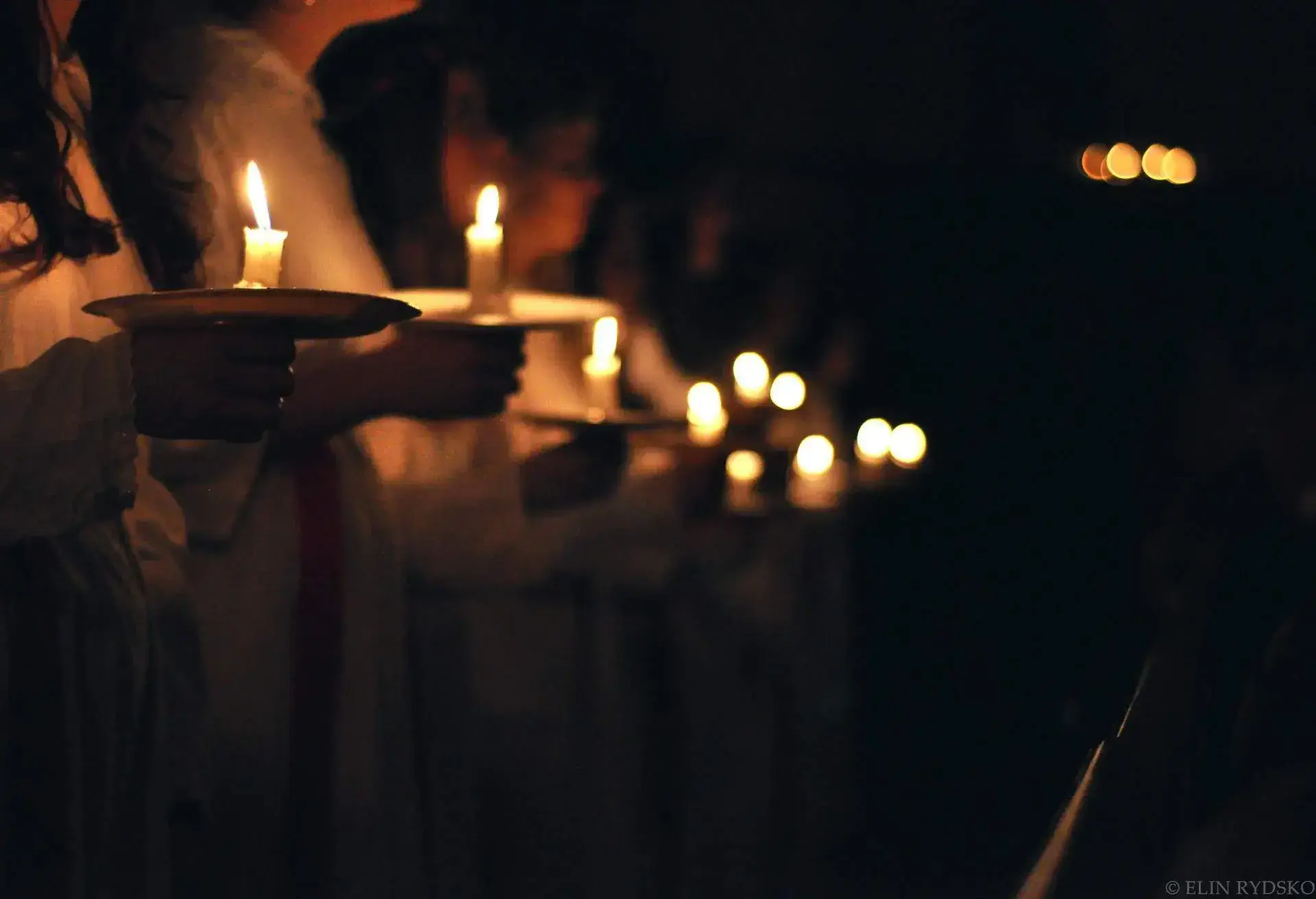 Saint Lucy Day, Sweden, people holding candles at night