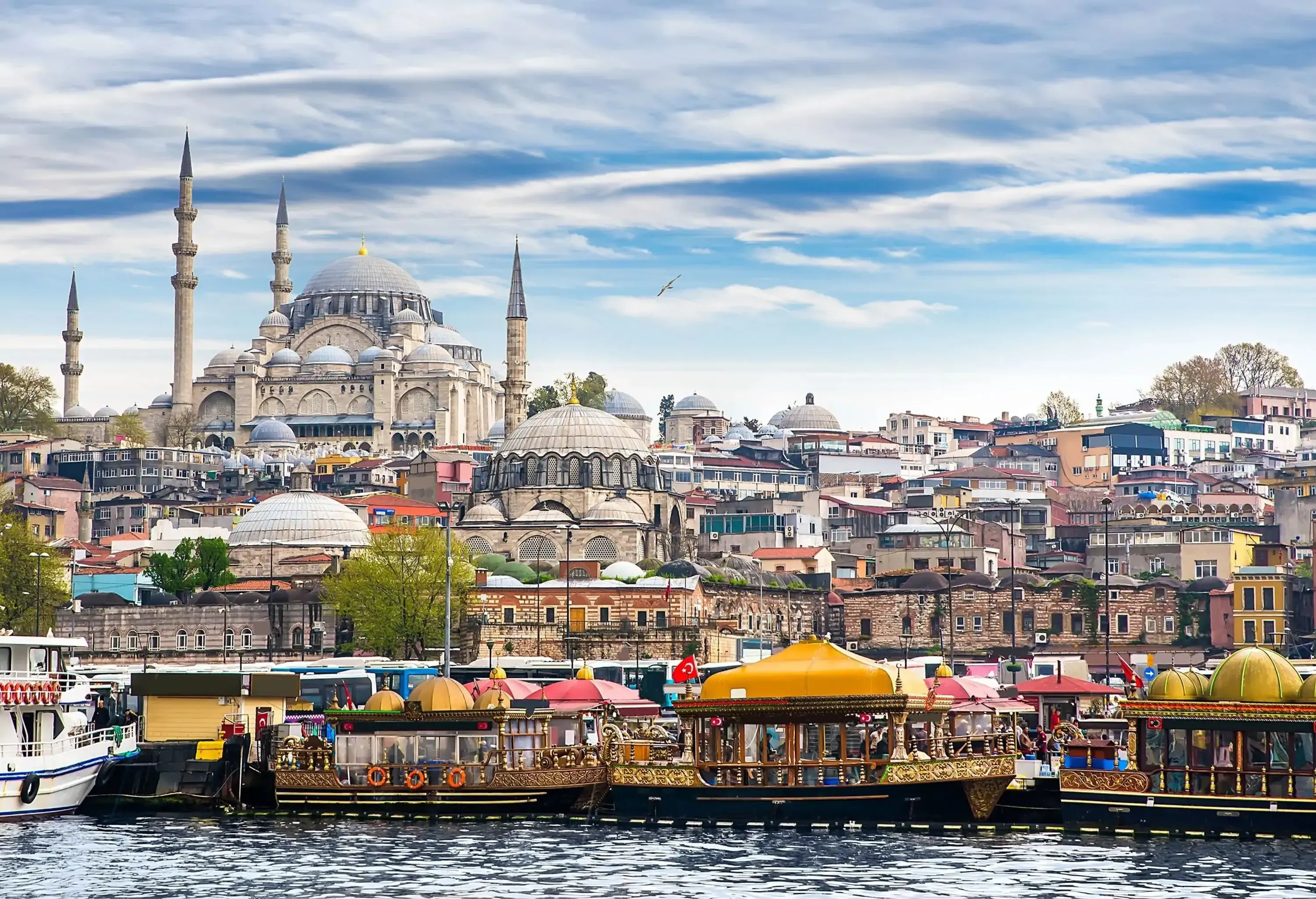 Magnificent architecture along the Bosporus shore, with floating restaurants bobbing in the harbour.