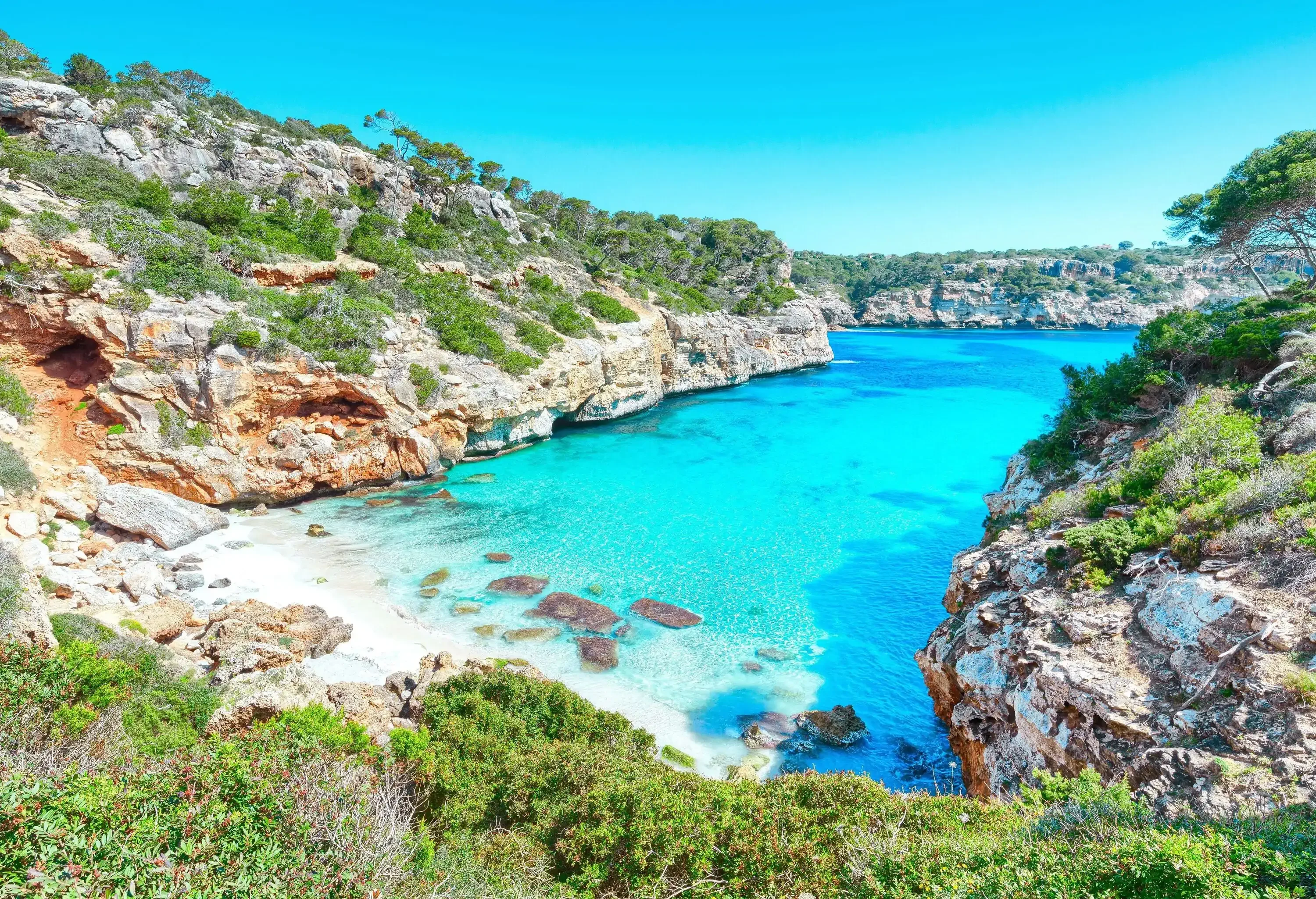 A bay with small cove and turquoise water in a Mediterranean island