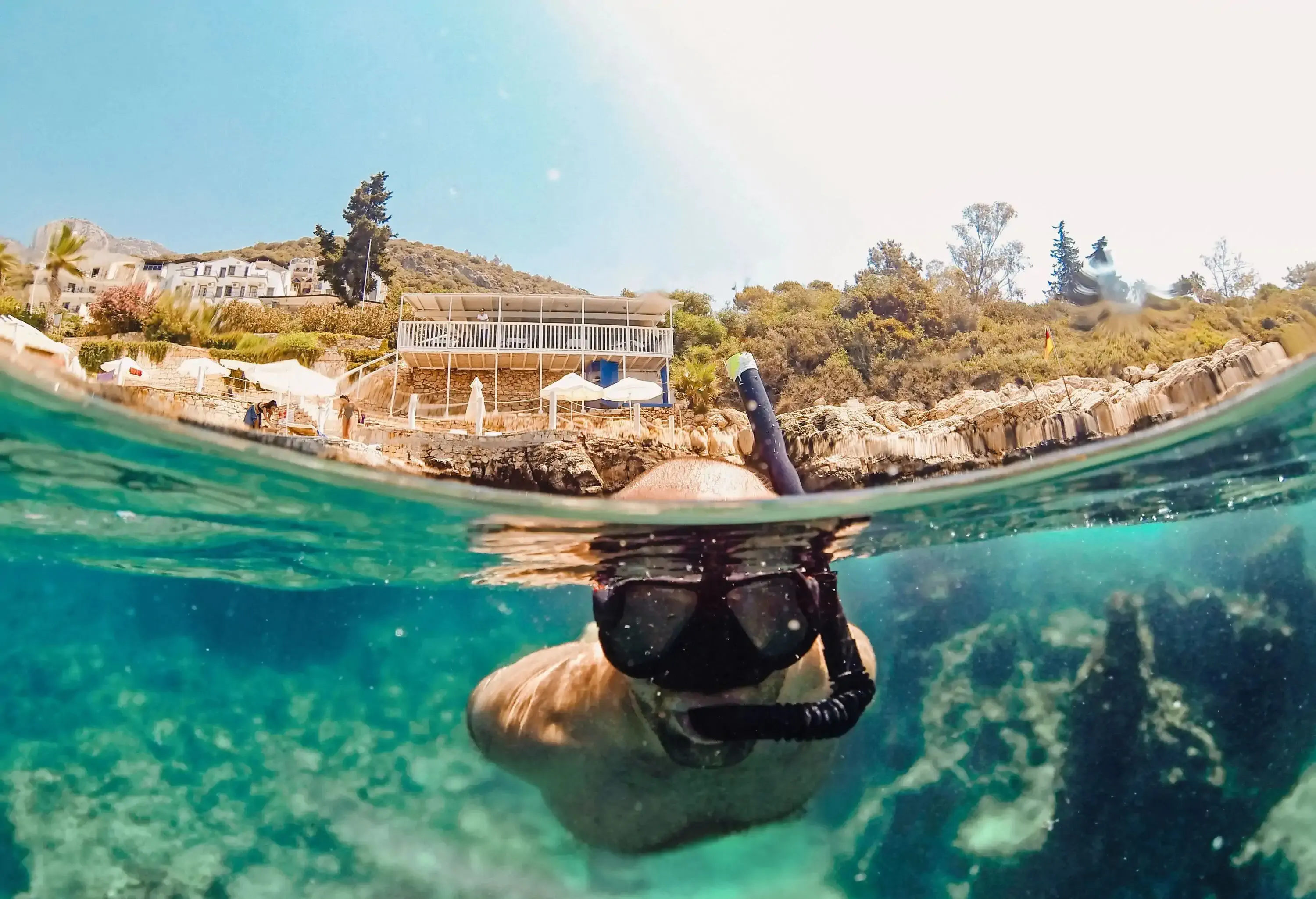 Young man snorkeling underwater in Turkey, Kaş. Turquoise blue water. Travel destinations.