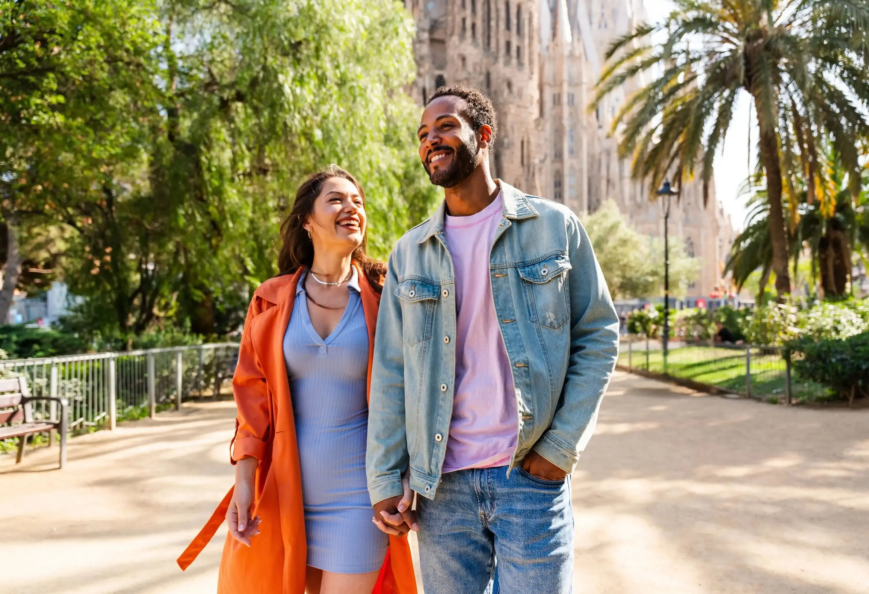 Multiracial beautiful happy couple of lovers dating at Sagrada Familia, Barcelona