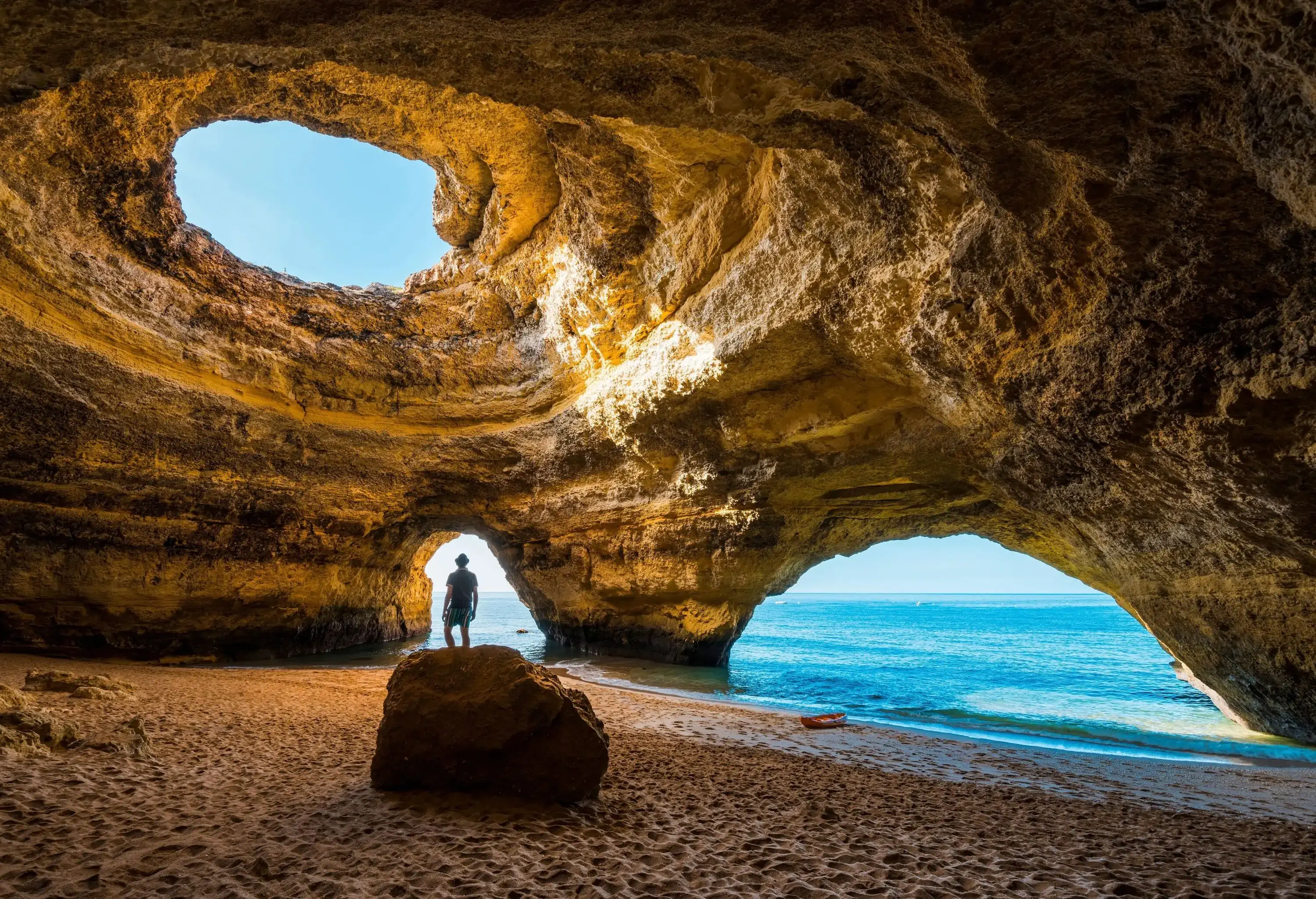Solitary man inside a beach cave, Portugal