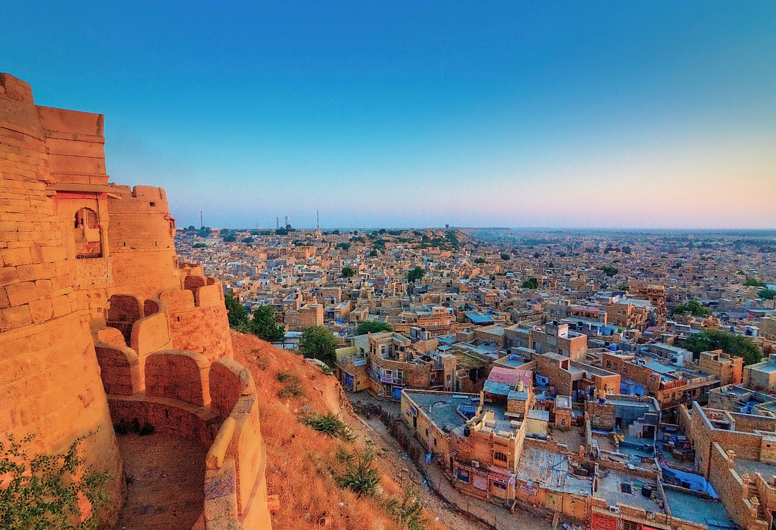 A brown brick fortress overlooking the ancient buildings and dwellings sprawled across the cityscape.