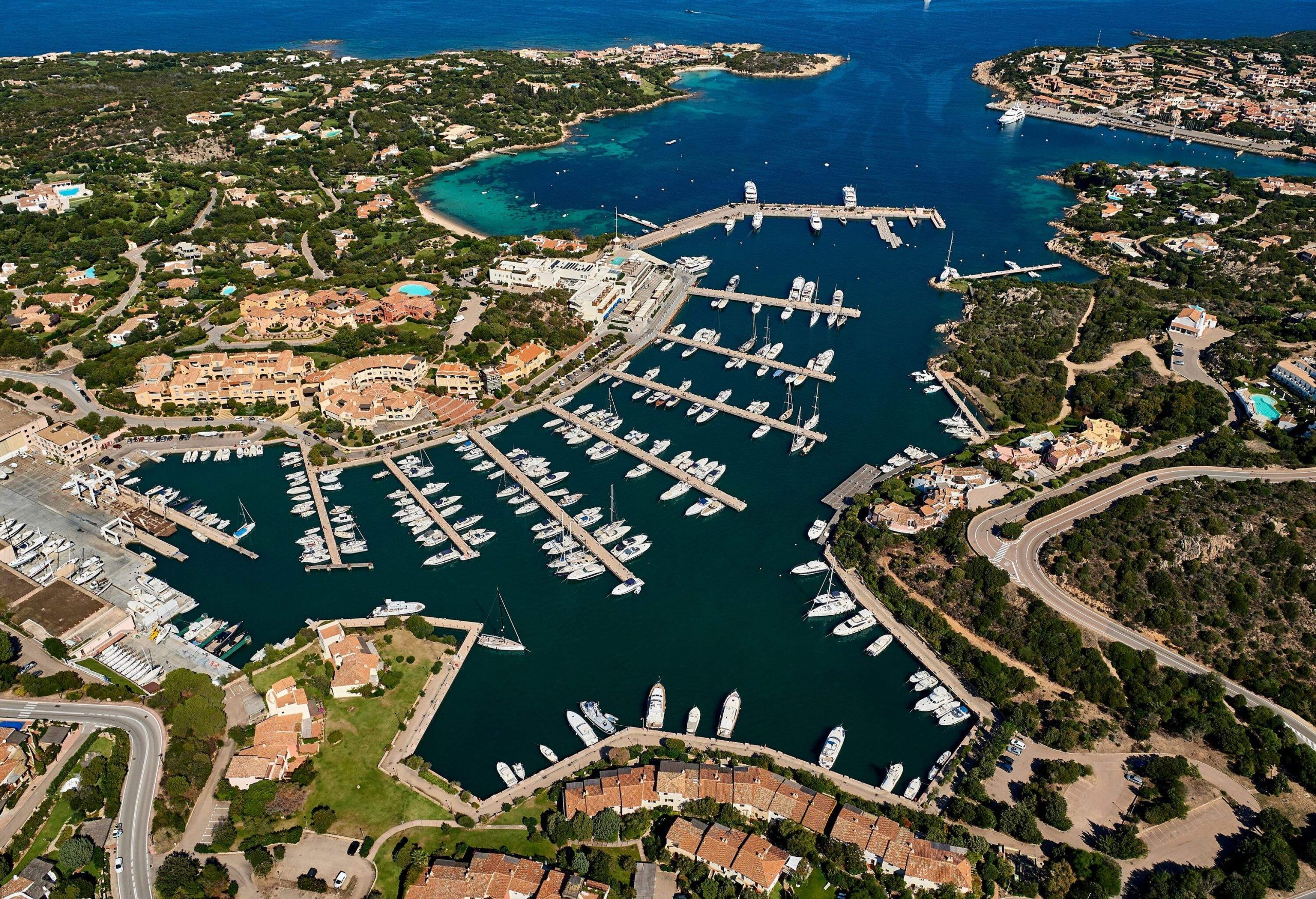 A large port with multiple yacht marinas and coves in a beautiful resort town.