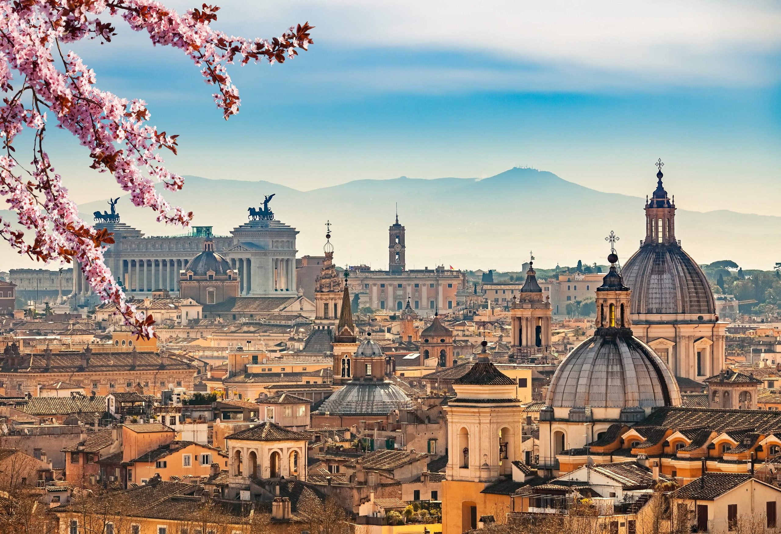 The striking skyline of Rome accentuated by domed towers and historical landmarks.