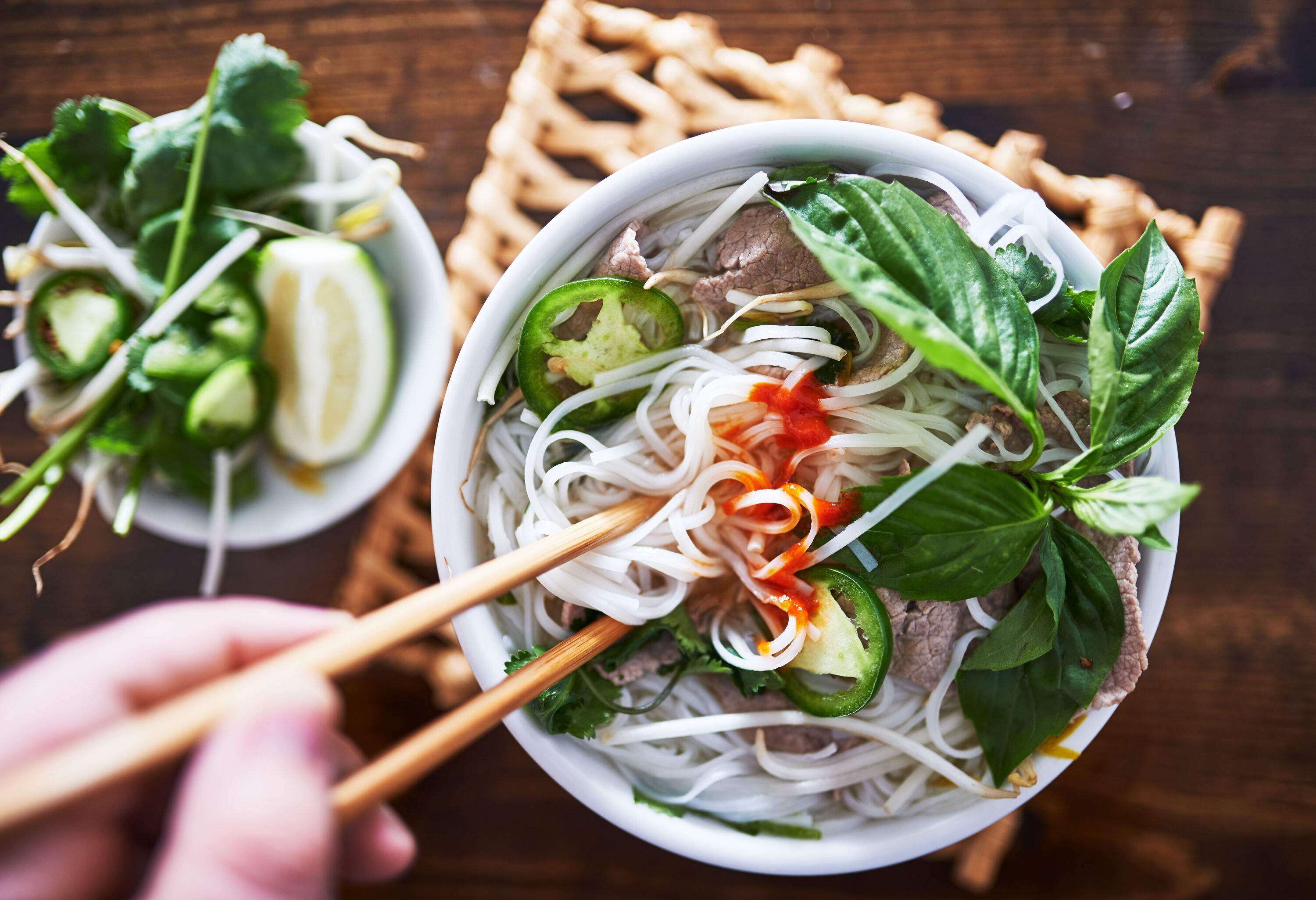 A tantalising bowl of Vietnamese pho, filled with fragrant broth, rice noodles, and an array of delicious toppings.