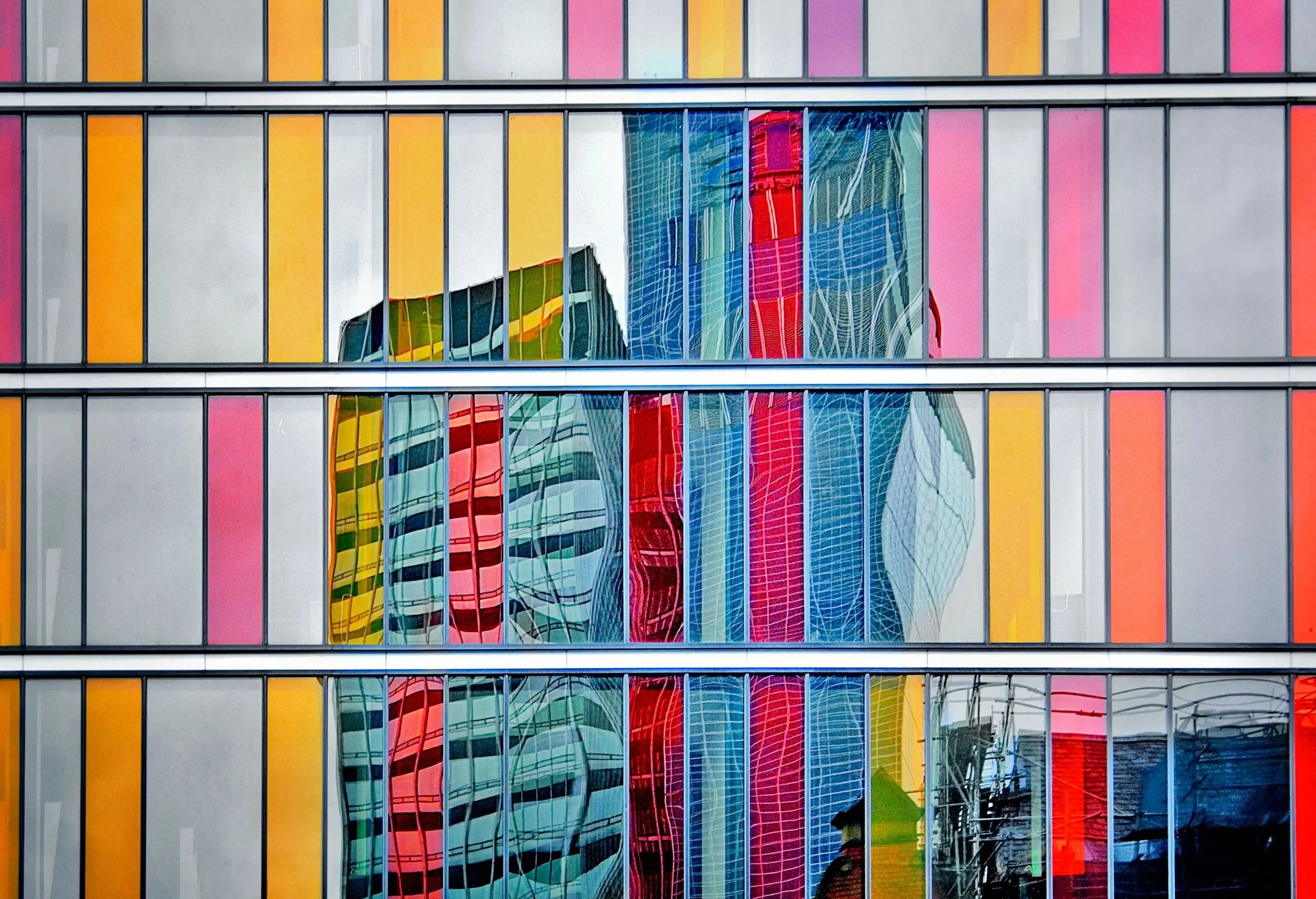 A colourful glass facade of a modern building.