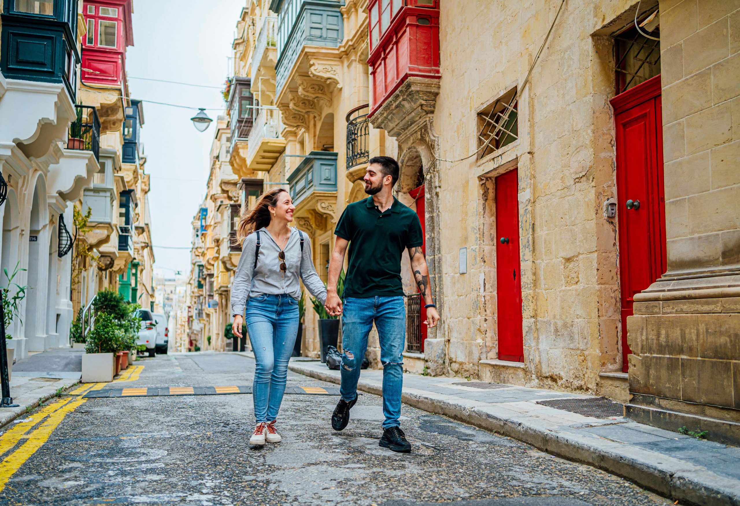 Young cheerful couple enjoying a walk together in Valletta, Malta