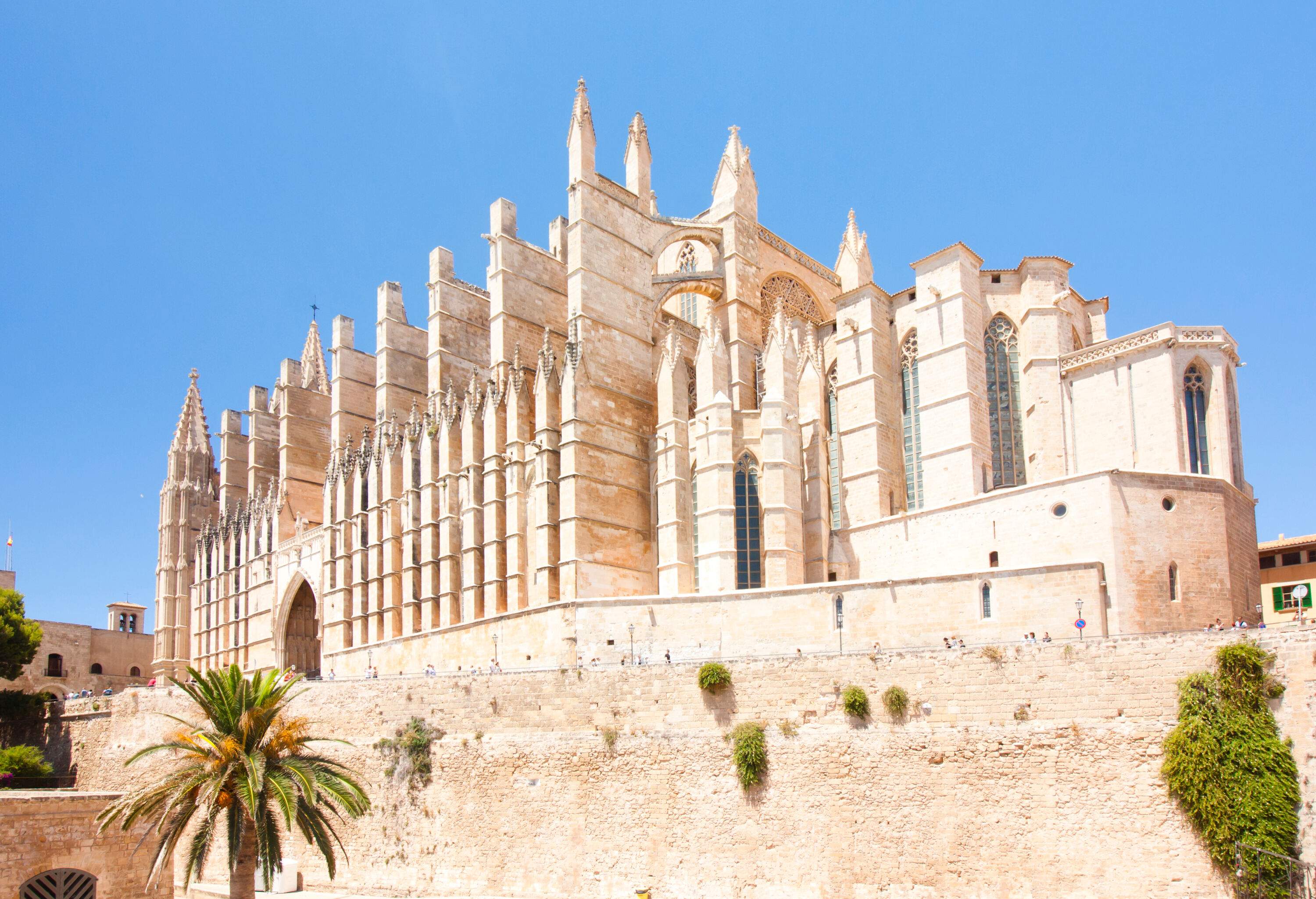 A stone, Levantine Gothic-style temple against the blue sky.