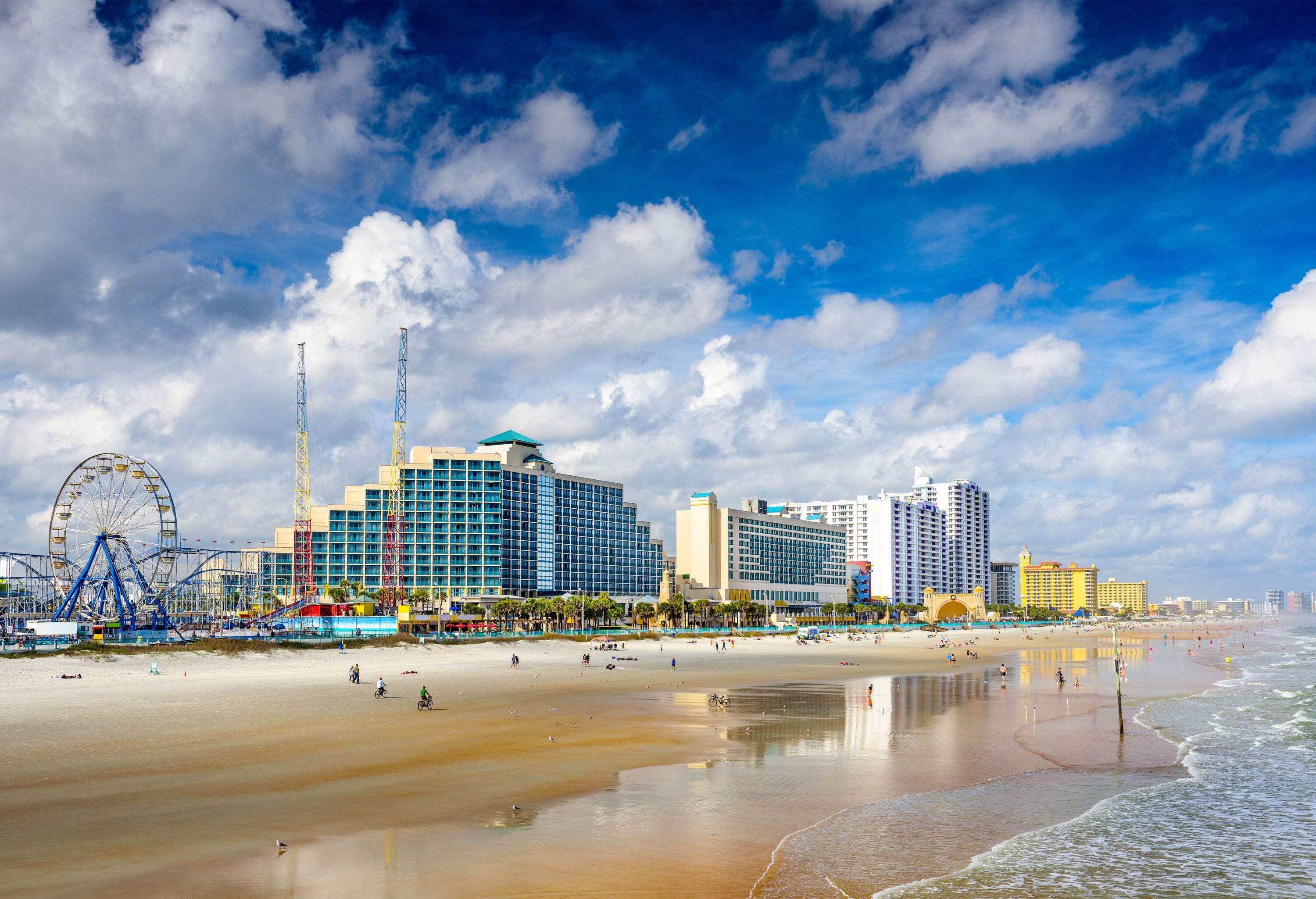 The beachfront skyline of Daytona Beach stretches along the beautiful coastline, showcasing a vibrant cityscape against the backdrop of the sparkling ocean.