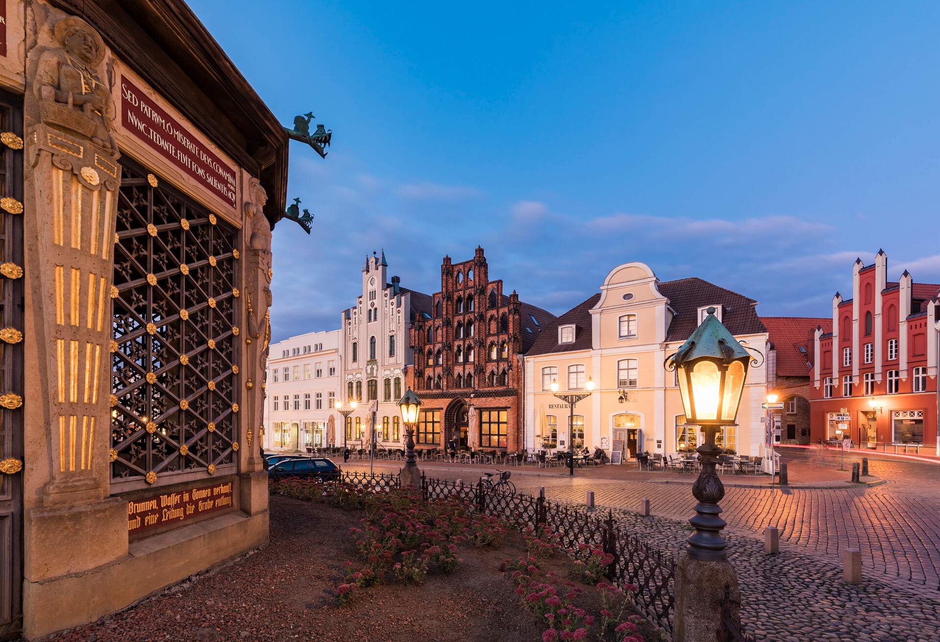 Traditional homes dot a brick-paved street.