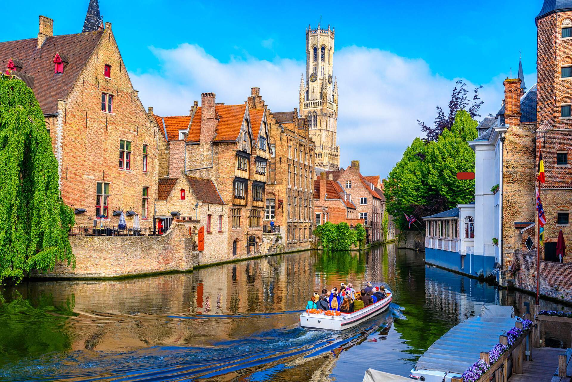 A group of people taking a boat tour of the city's monumental architecture.