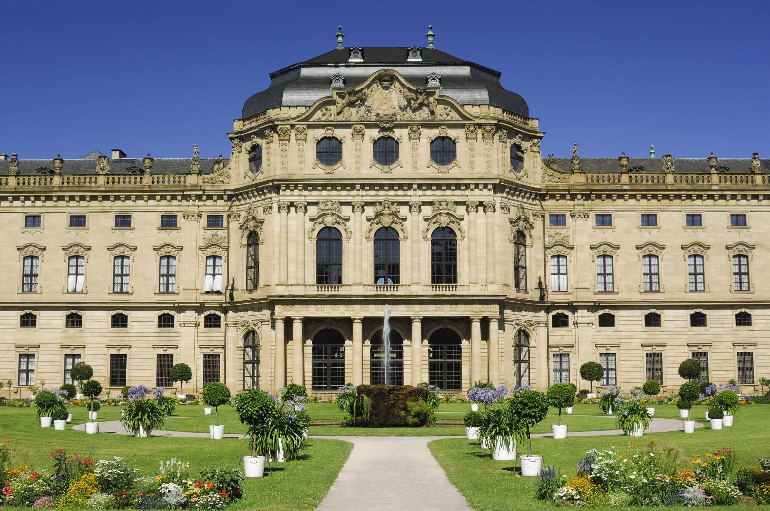 The impressive baroque palace Würzburg on a sunny day with it's beautiful green garden in the front