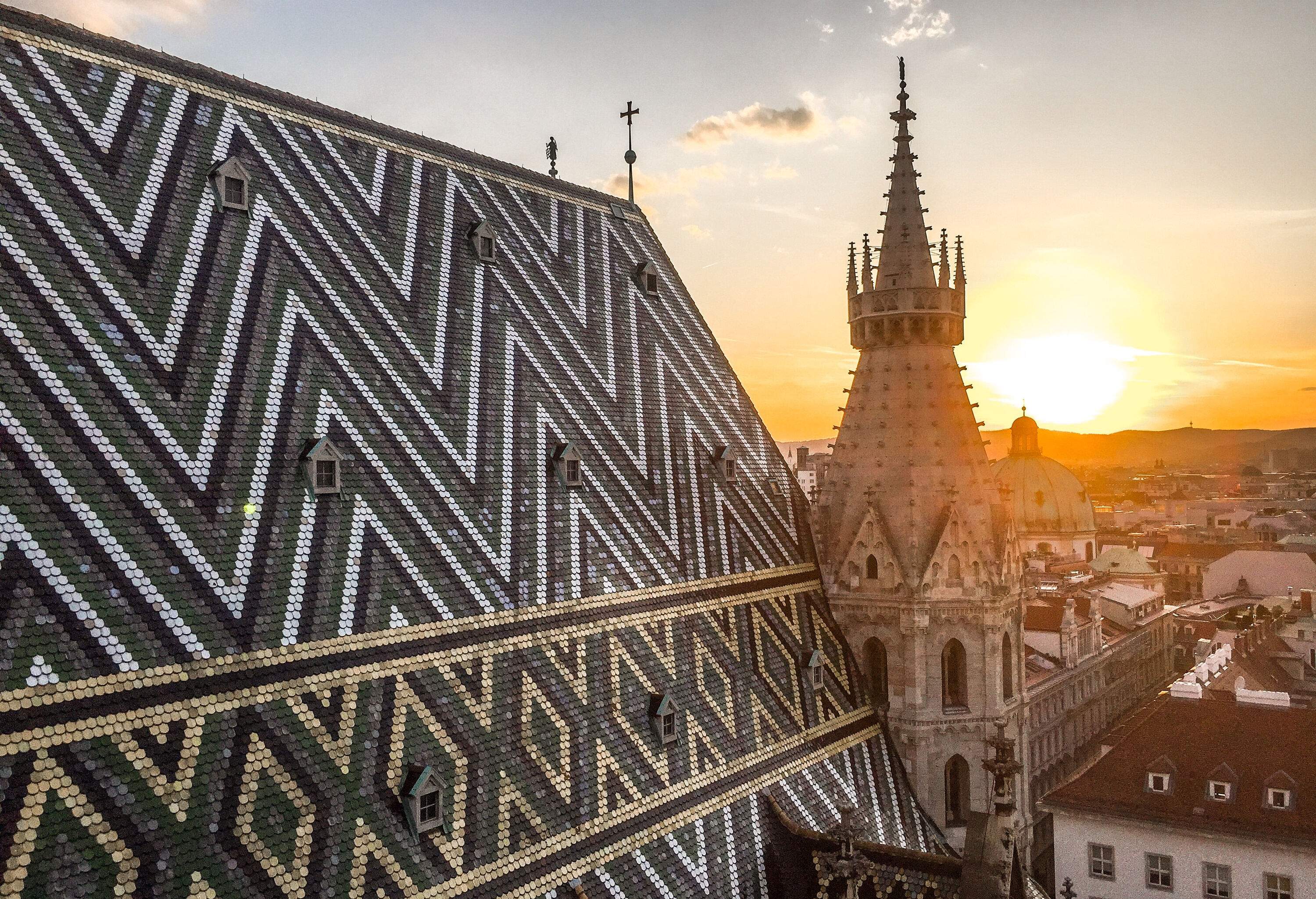 The striking roof of St. Stephen's Cathedral boasts an intricate pattern of colourful tiles, creating a captivating visual display that reflects the Gothic masterpiece's architectural grandeur.