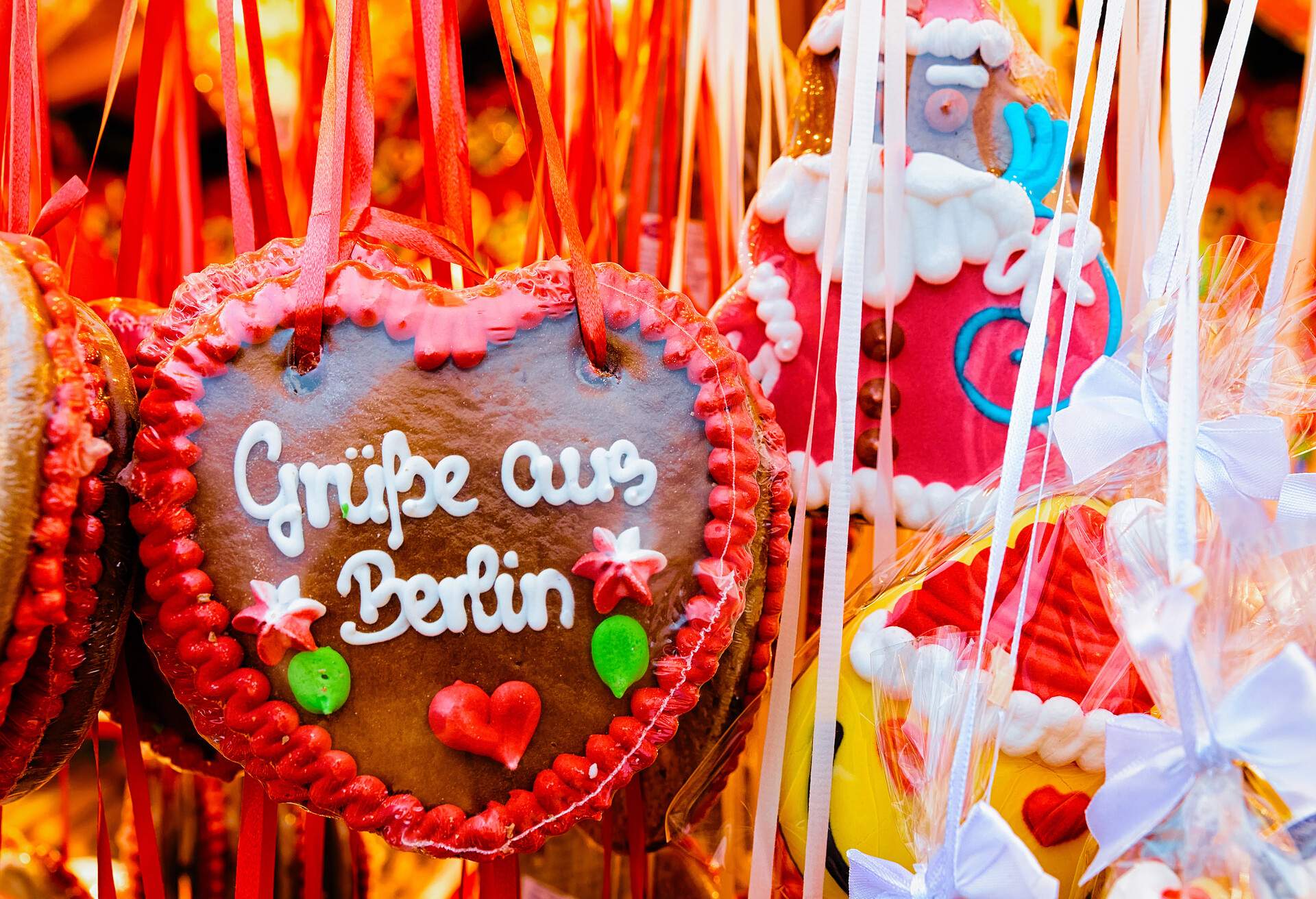 Heart shape Gingerbread cookies food on Christmas market in Europe in winter. German Night street Xmas and holiday fair in European city or town, December. Gendarmenmarkt in Berlin, Germany.