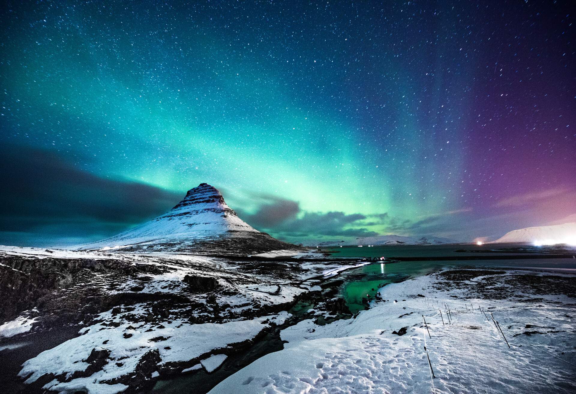 Exquisite Northern Lights in the starry night sky above the snow-covered land. 
