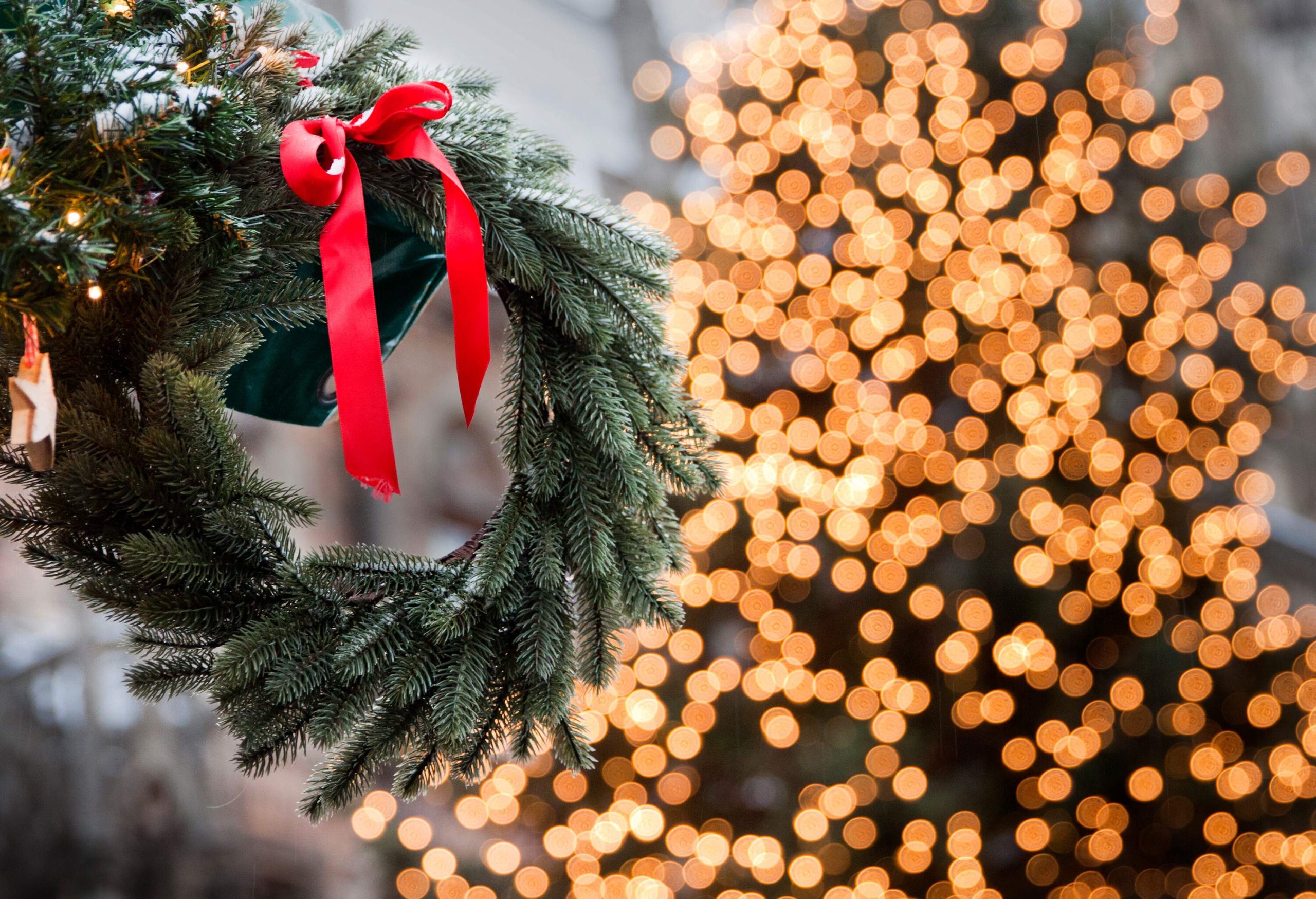 A festive decoration against a blurred series of lights.