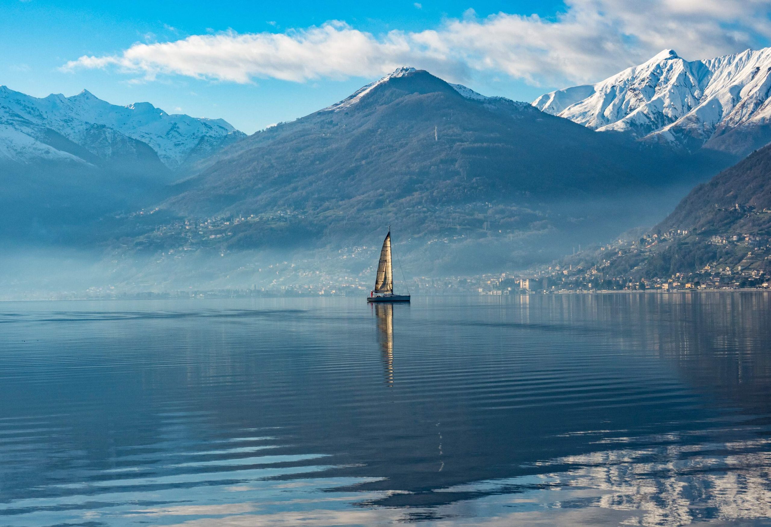 Sailboat on Lake Como at morning hours.