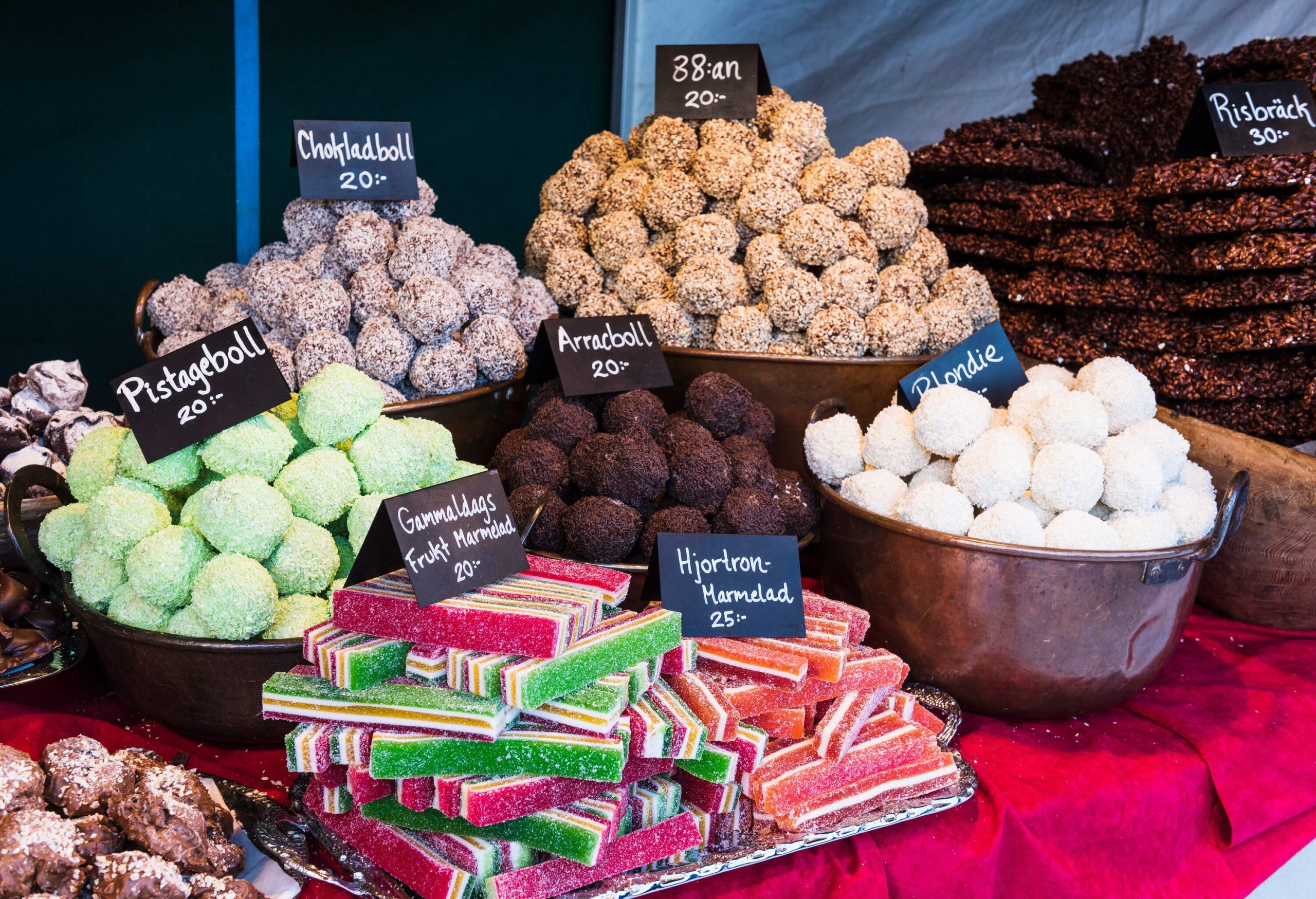 Different candies and sweets are displayed on the market for sale.
