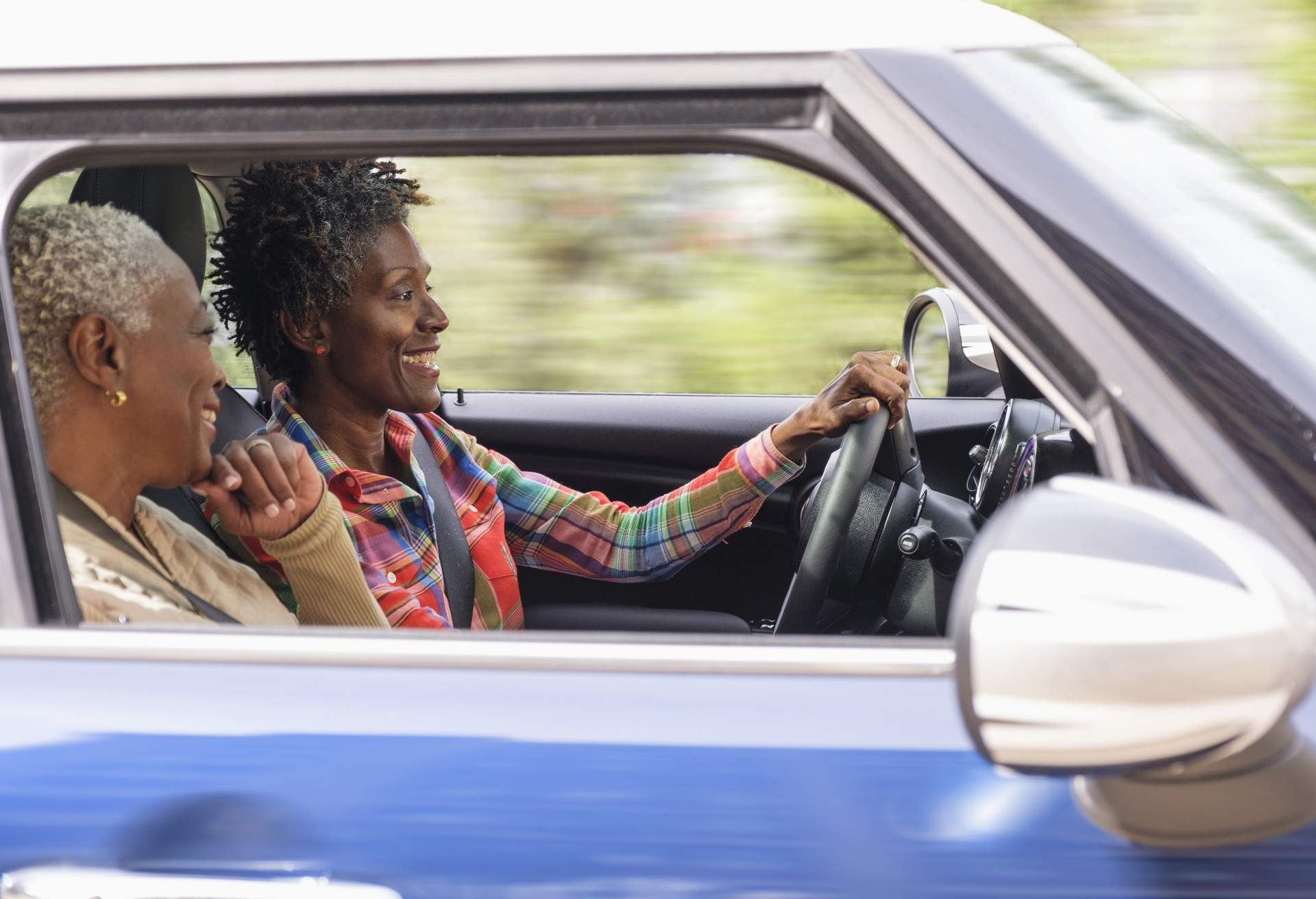 Two smiling women in car