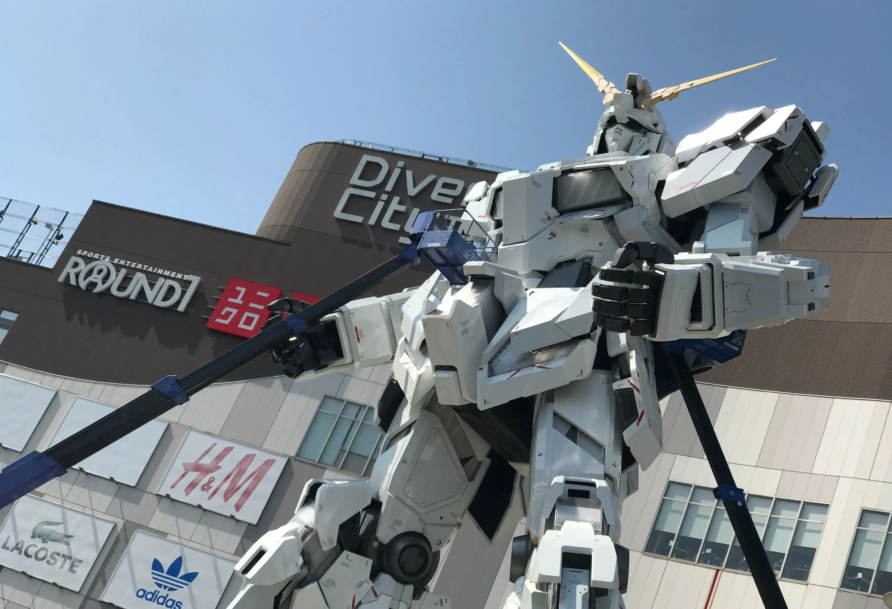 Gundam, an enormous white robot statue in front of a shopping mall.