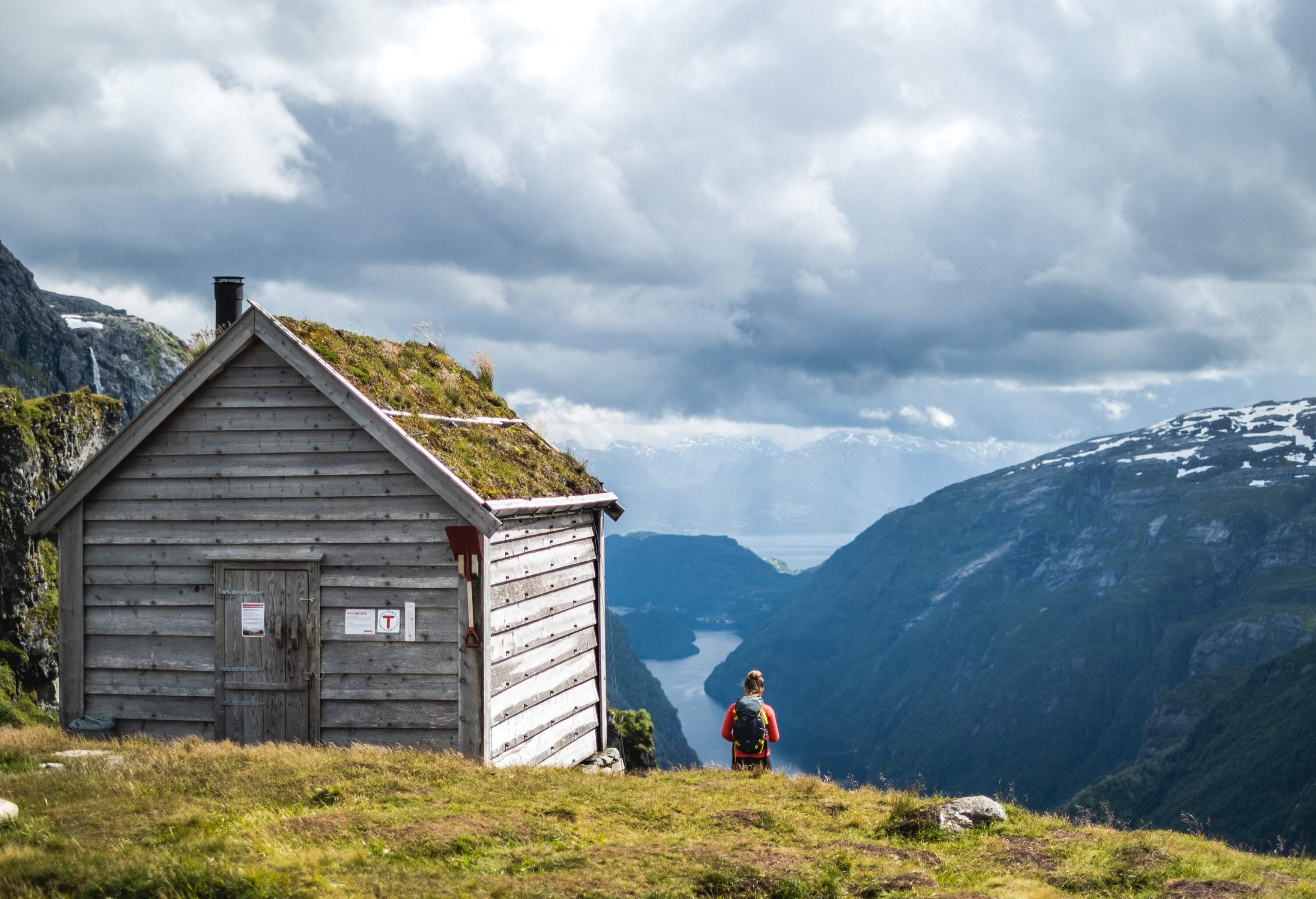 Woman by Kiellandbu in front of Hardanger fjord in Norway.