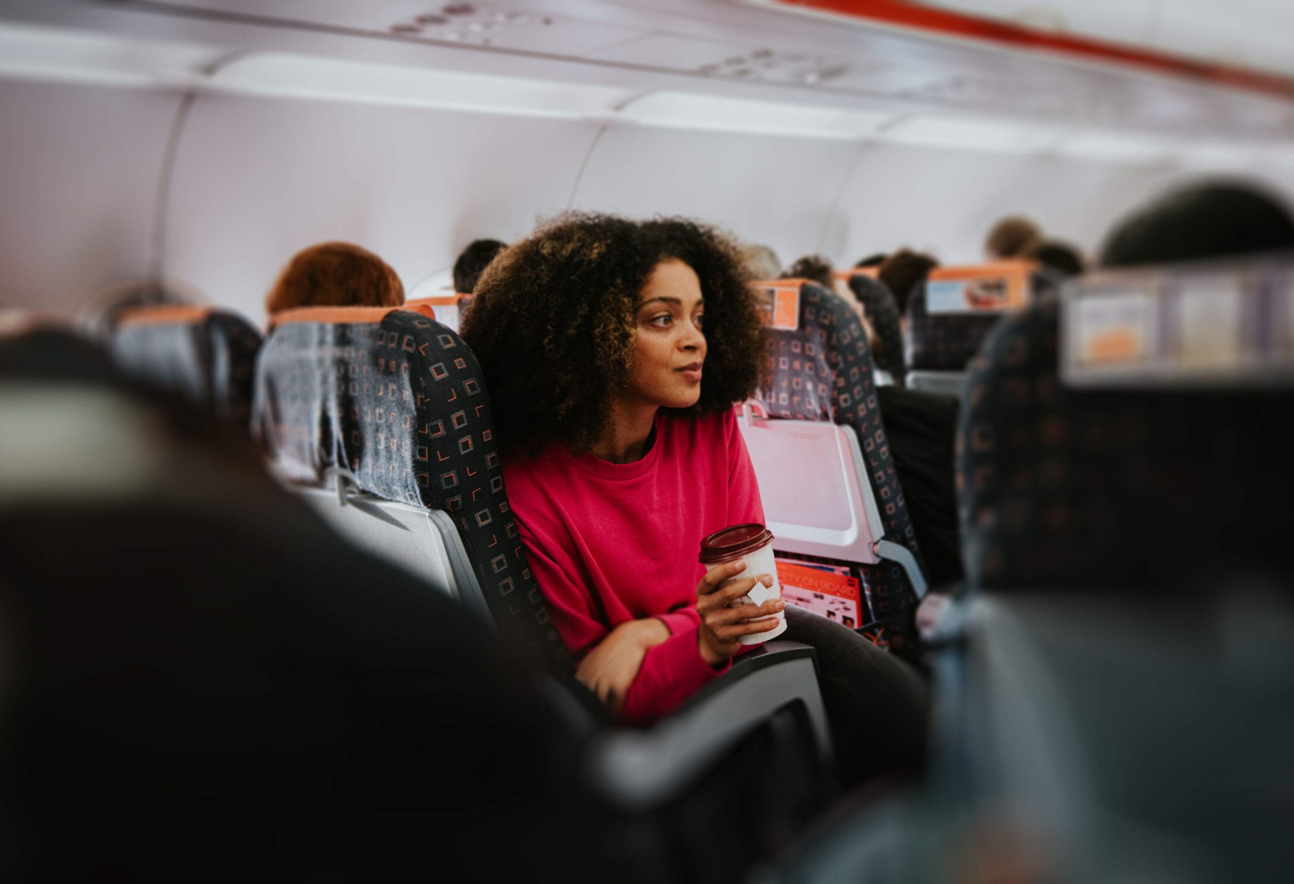 Woman drinking coffee on a plane