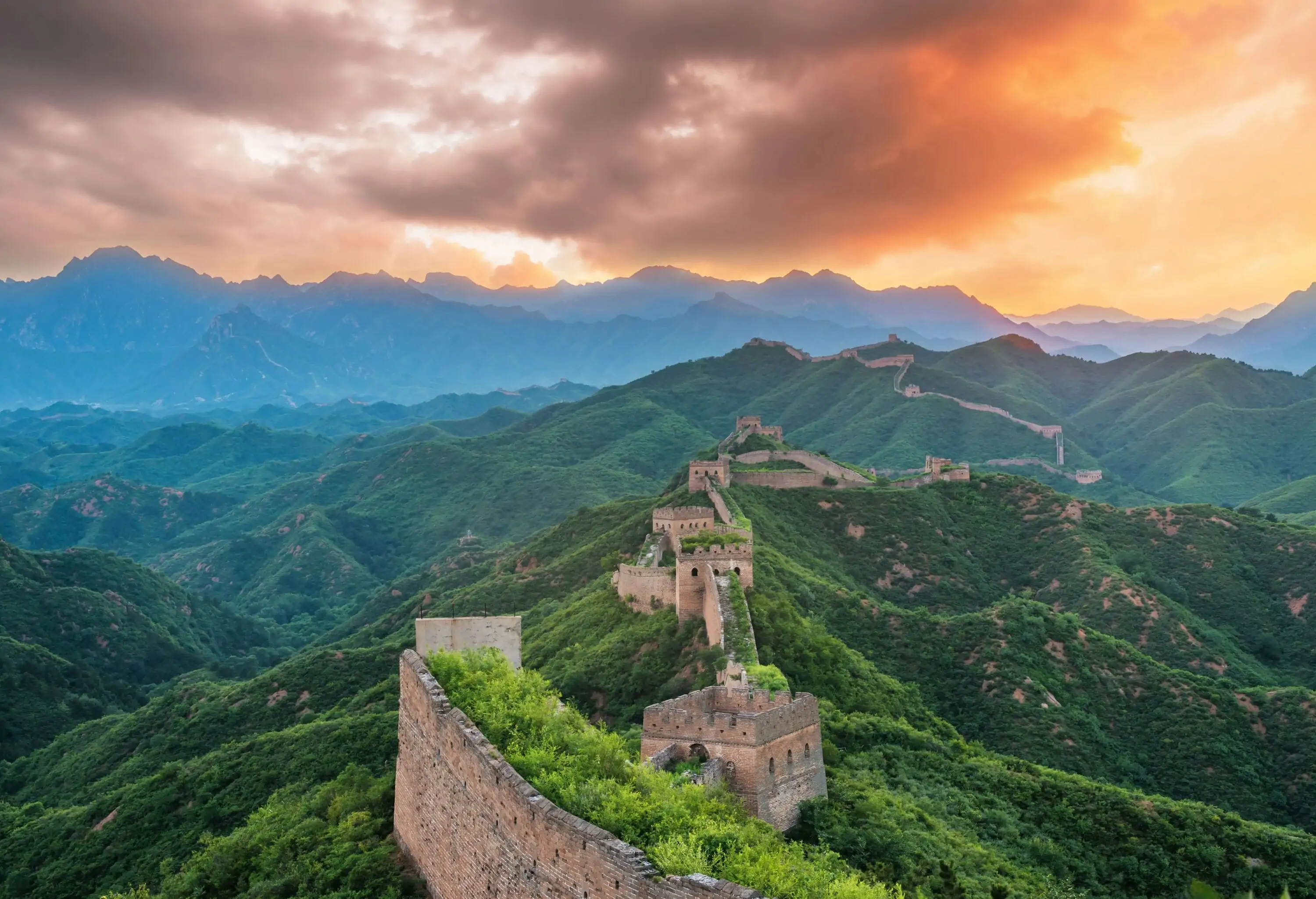 The magnificent Great Wall of China, surrounded by a spectacular mountainous terrain.
