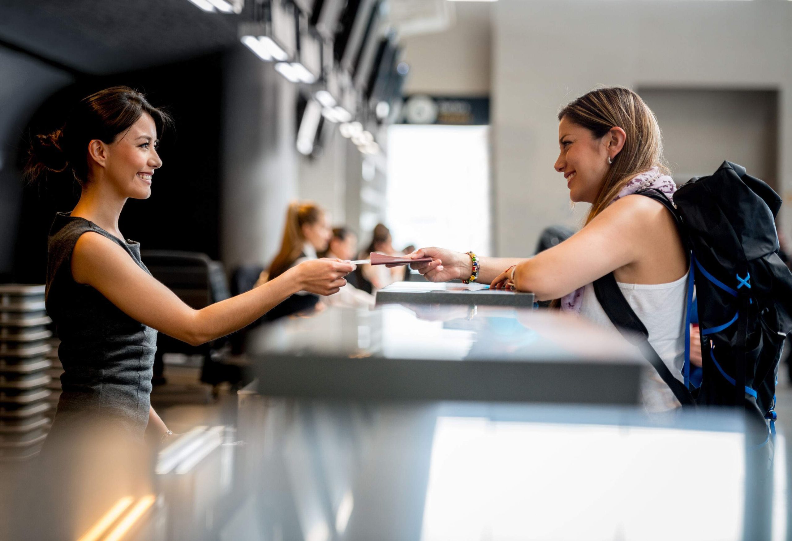 A female traveller checking in for her flight at the airport.