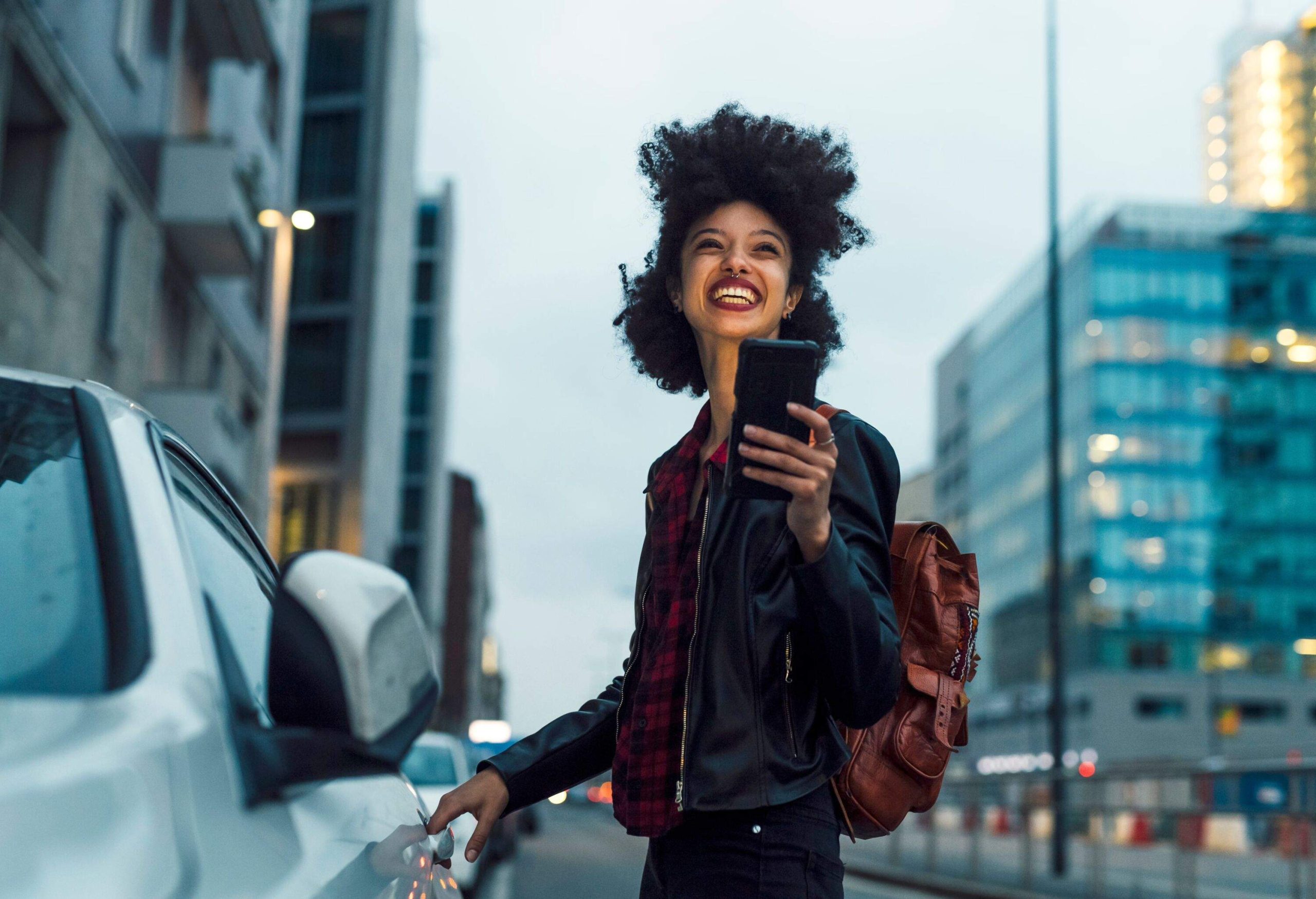 Young multiethnic woman outdoor using smartphone - Milan, Lombardy, Italy - technology, communication, social media concept