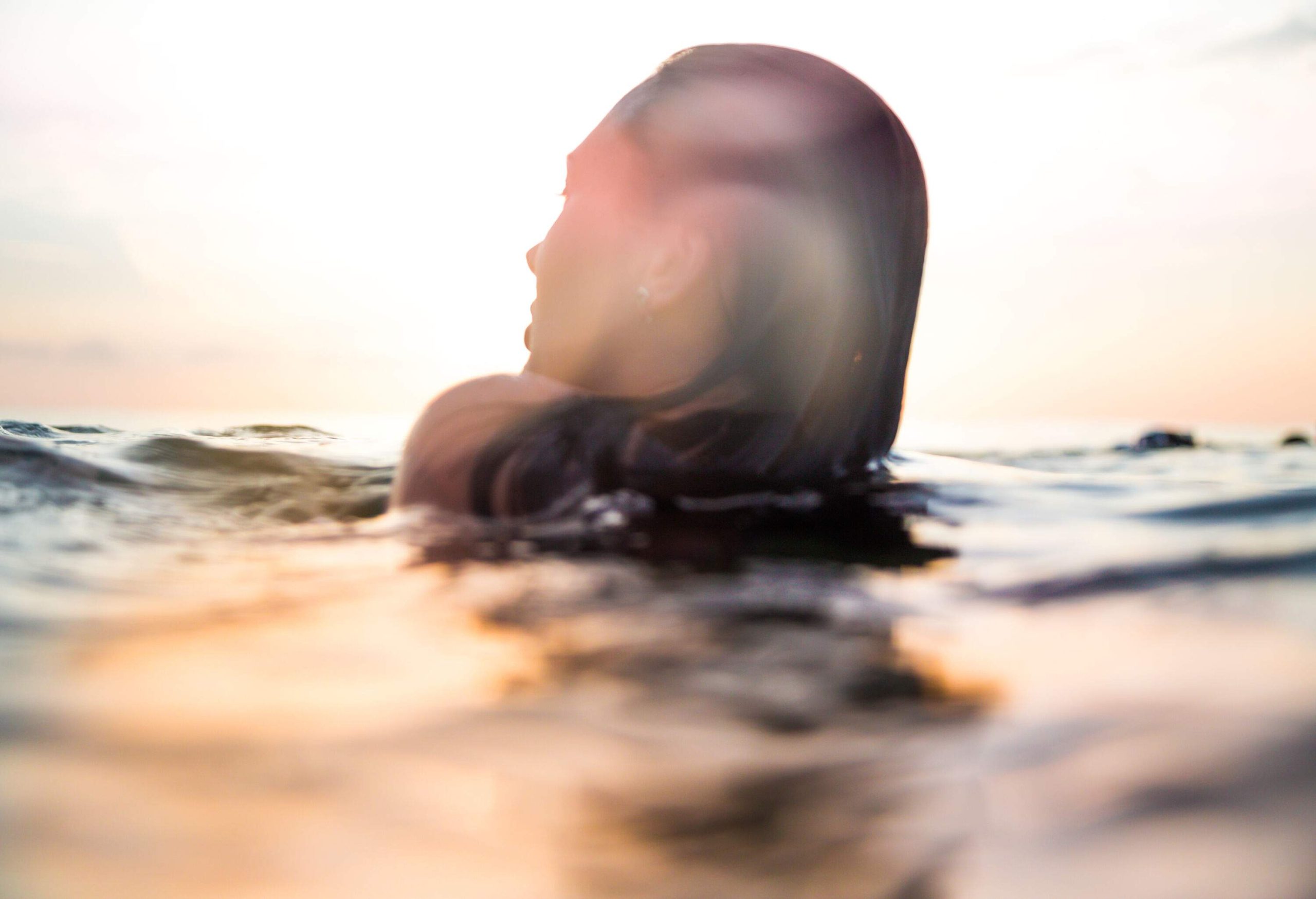 A woman's head above the surface of the water.