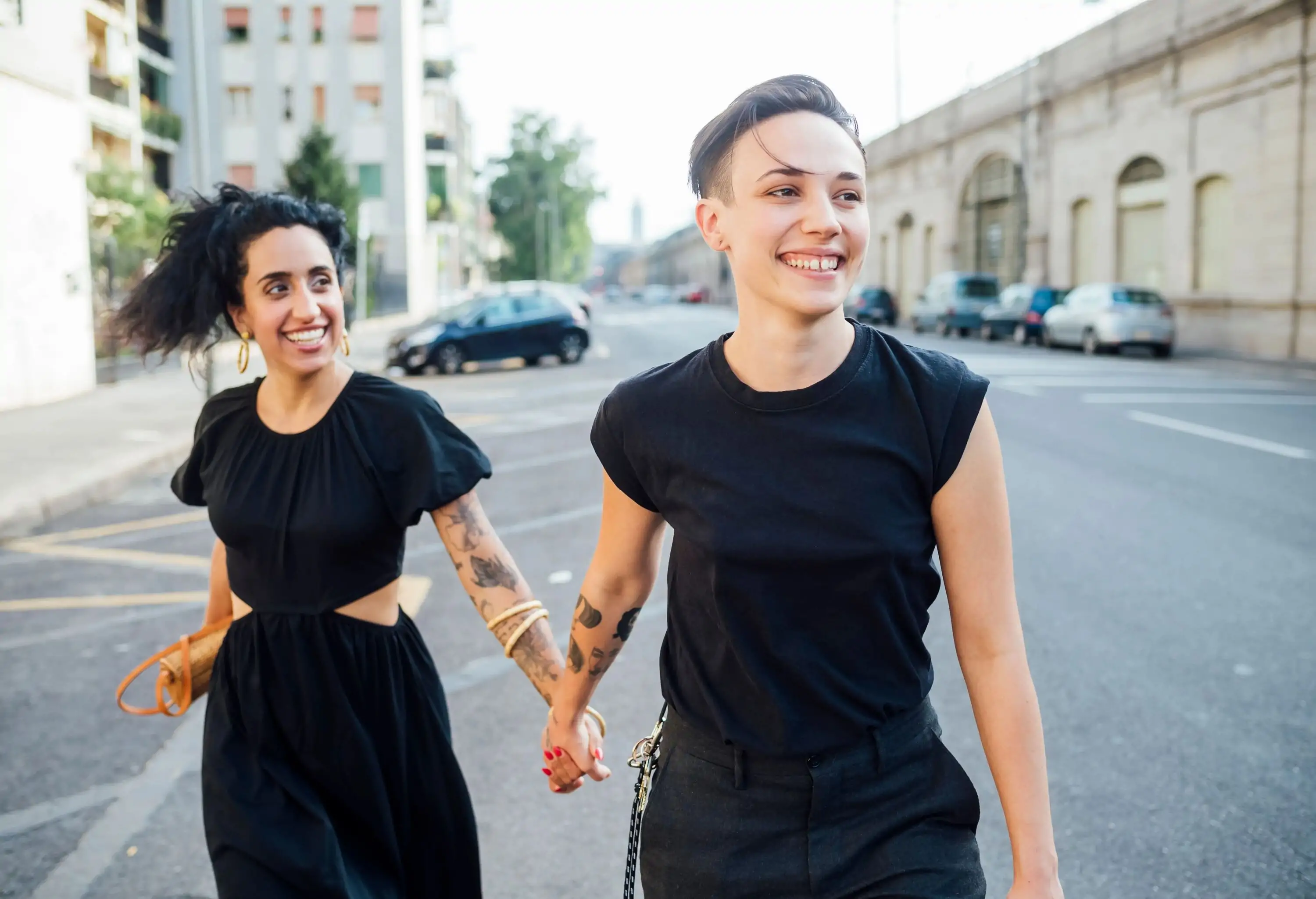 Smiling lesbian couple walking in city