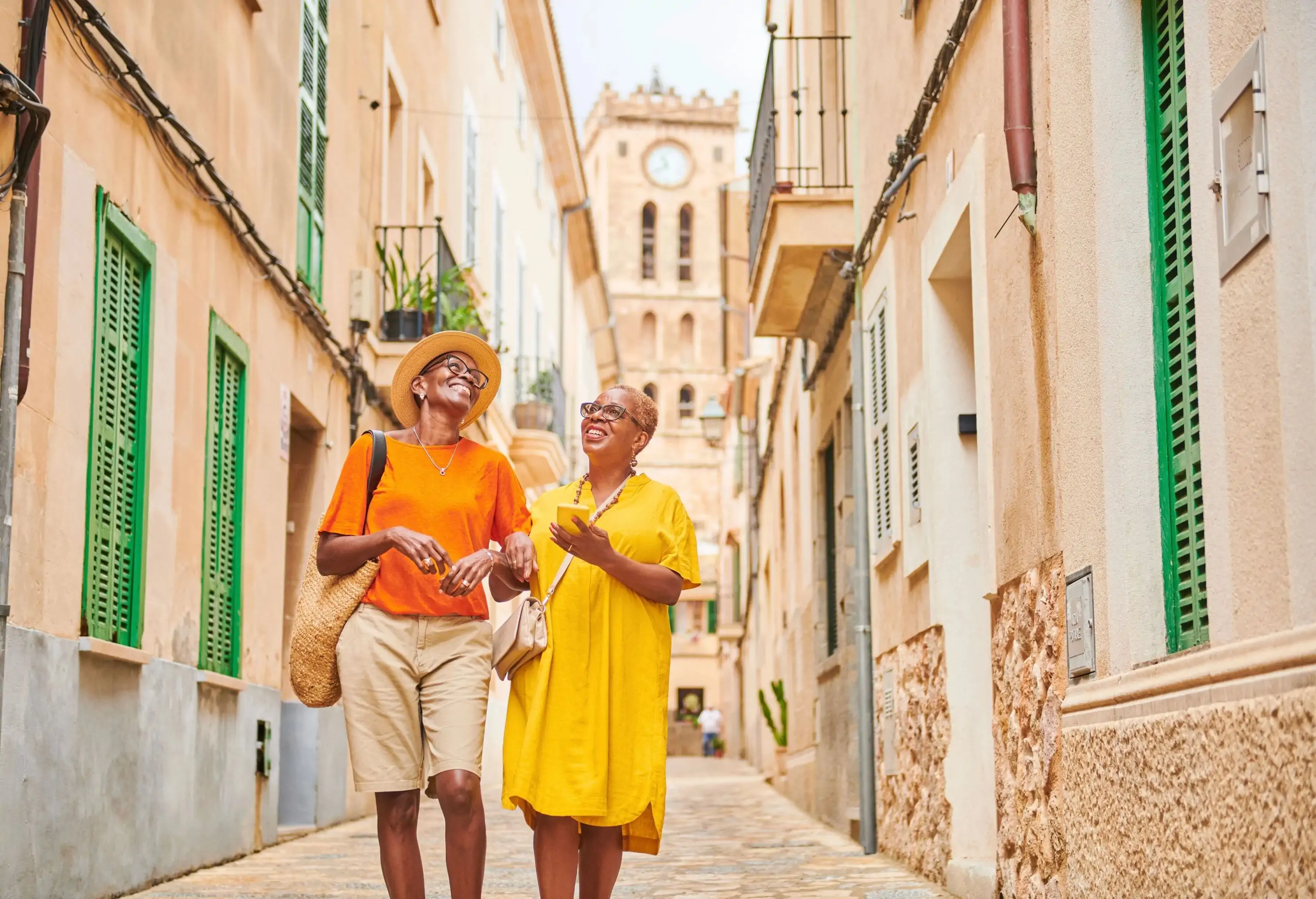 two women strolling a narrow street