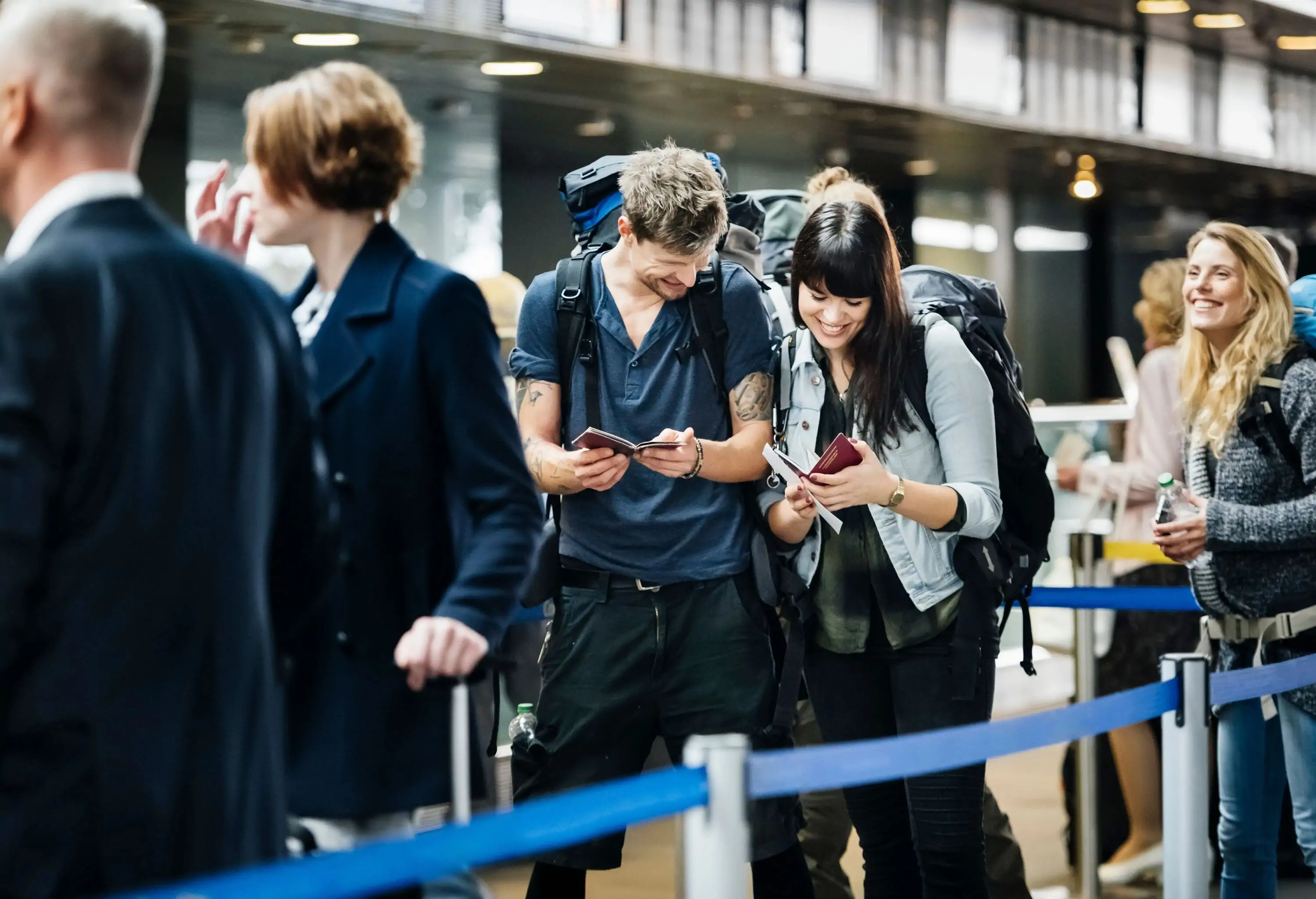 Backpacker couple checking mobile boarding pass on smart phone