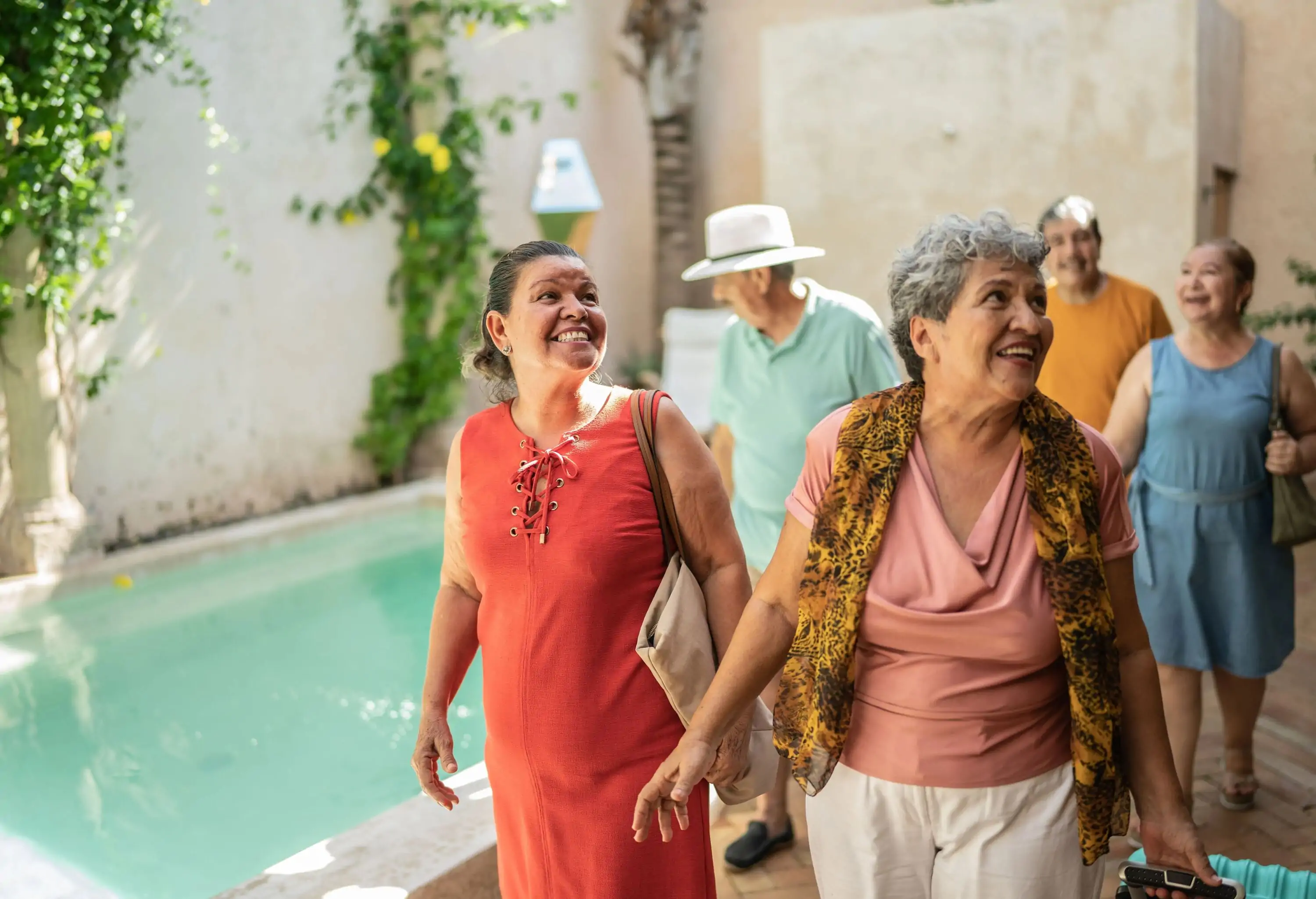 Group of senior friends talking while arriving to their accommodation