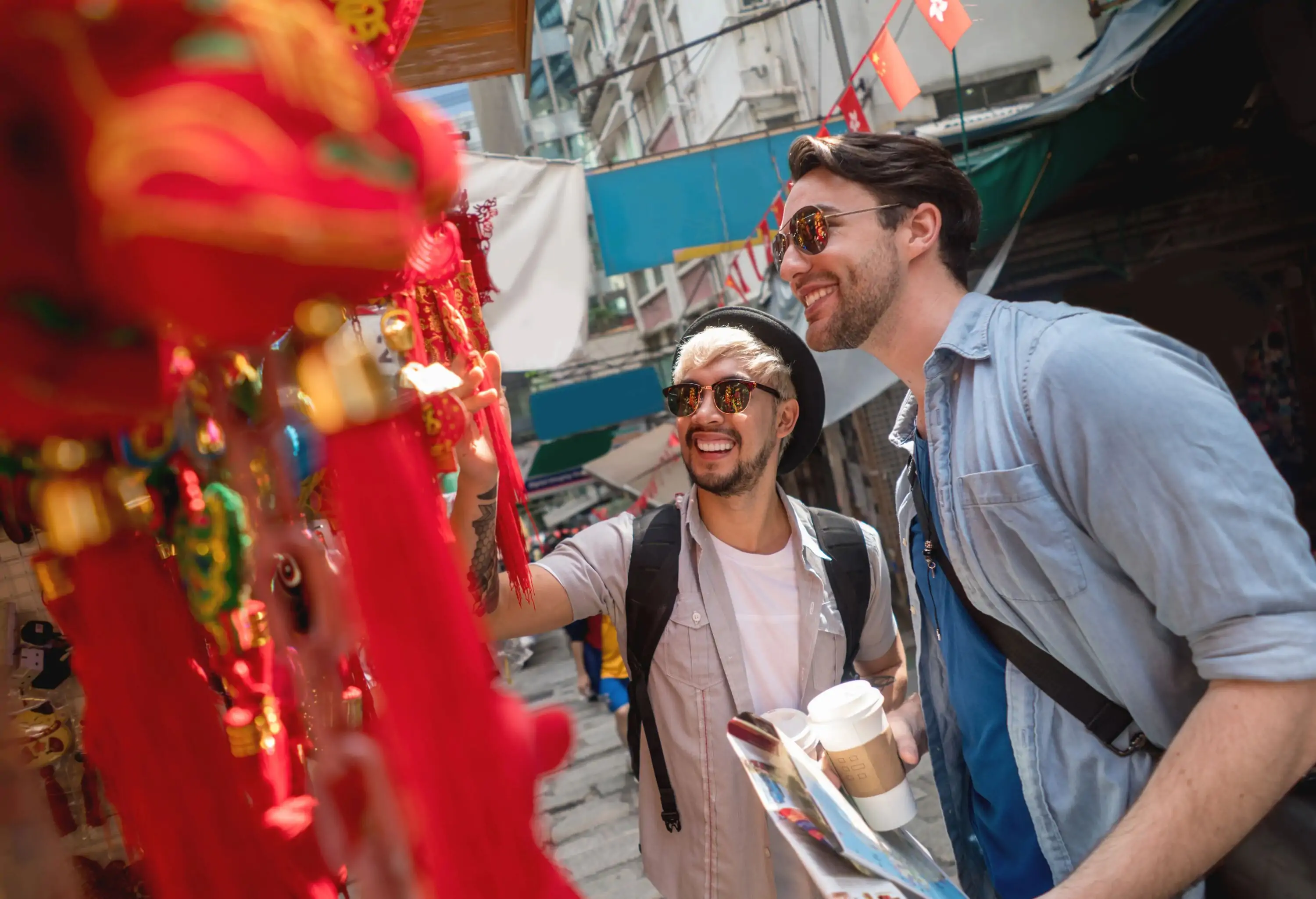 Happy gay couple looking at thing in a flee market
