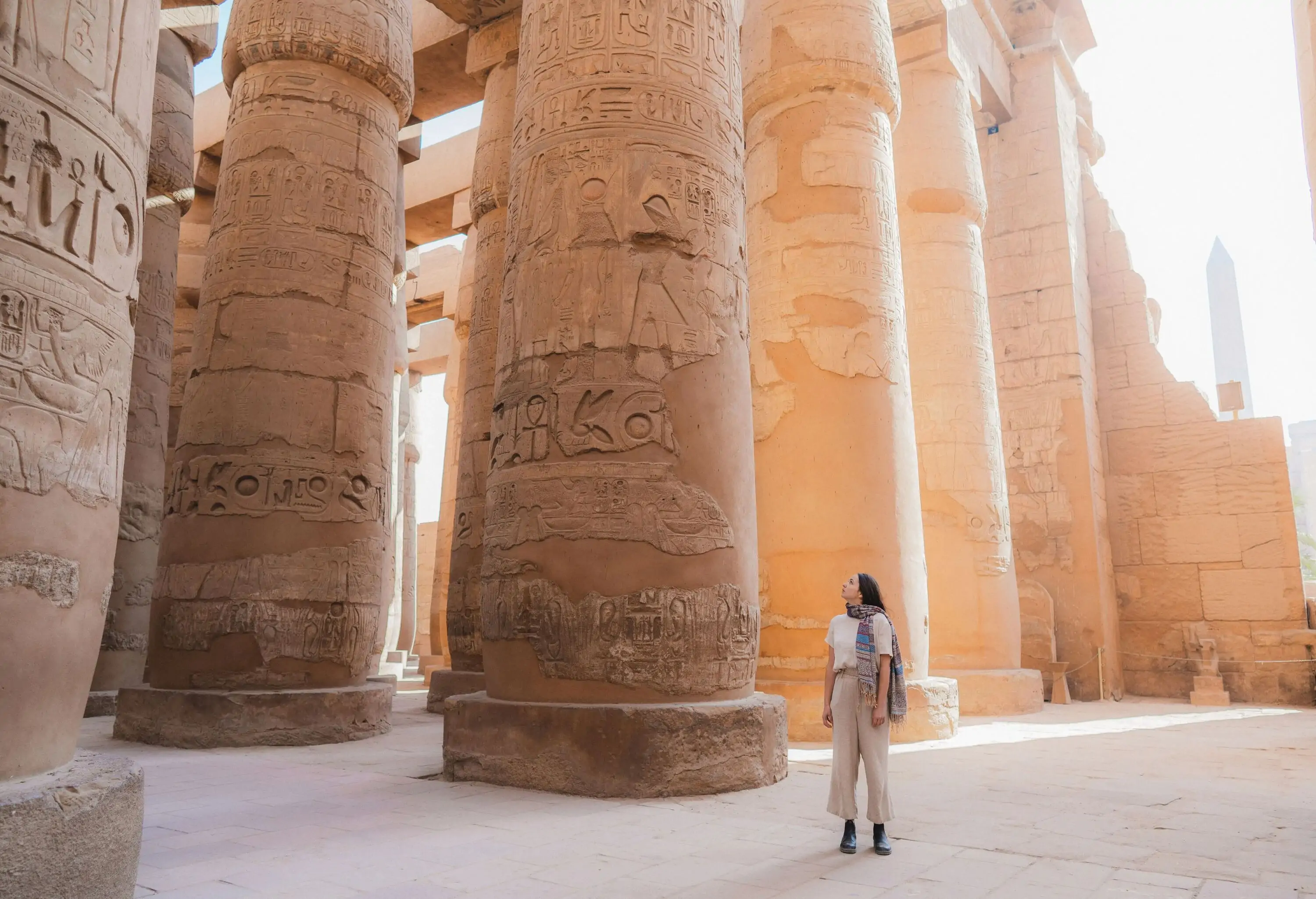 Young Caucasian woman walking in the ancient Egyptian temple in Luxor