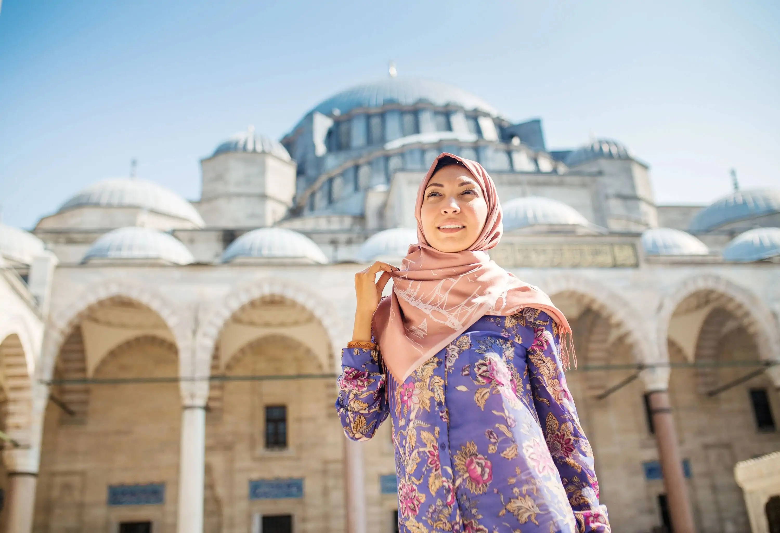 woman wearing hijab in Istanbul, Turkey, posing in courtyard of Suleymaniye mosque, religion and travel concept