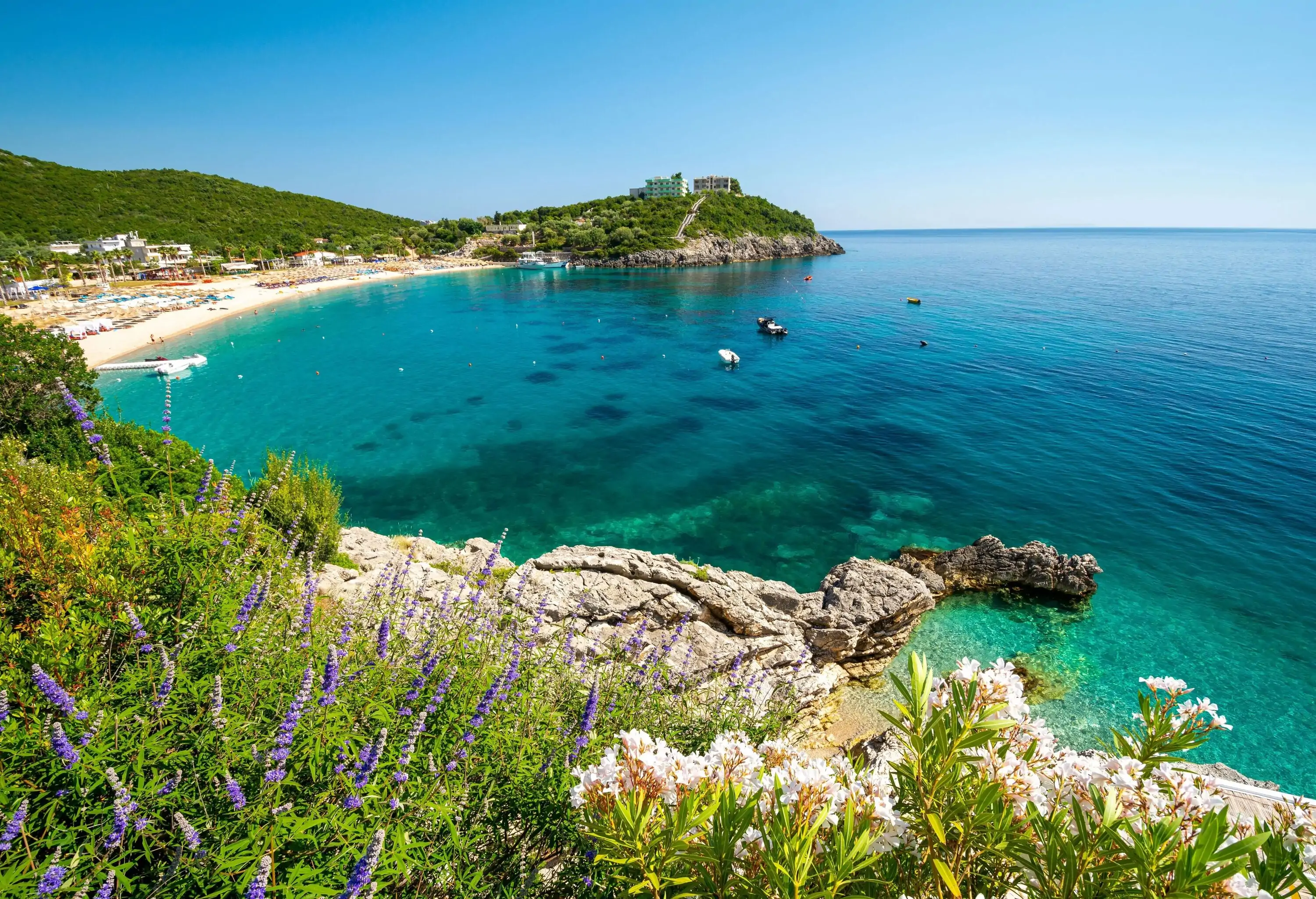 A Mediterranean cove of turquoise water and hills covered in shrubbery