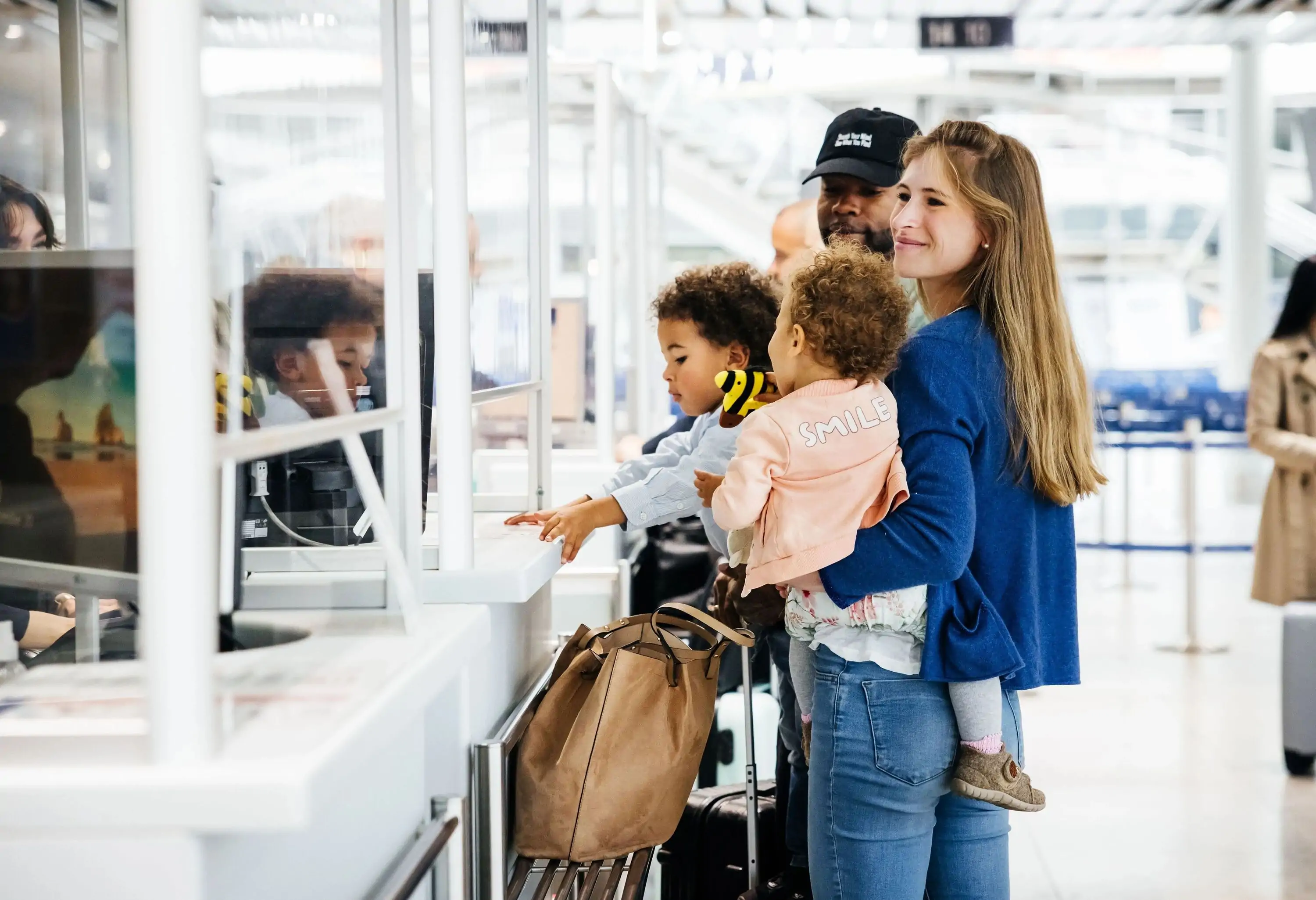 a family of four at the airport check-in