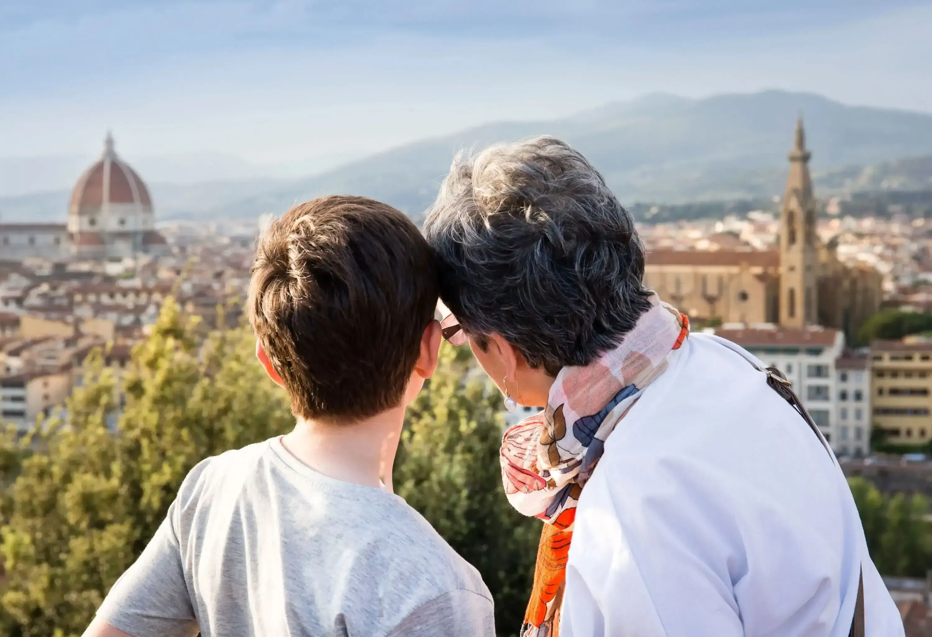 A kid and an older person gaze into the urban setting of the metropolis.