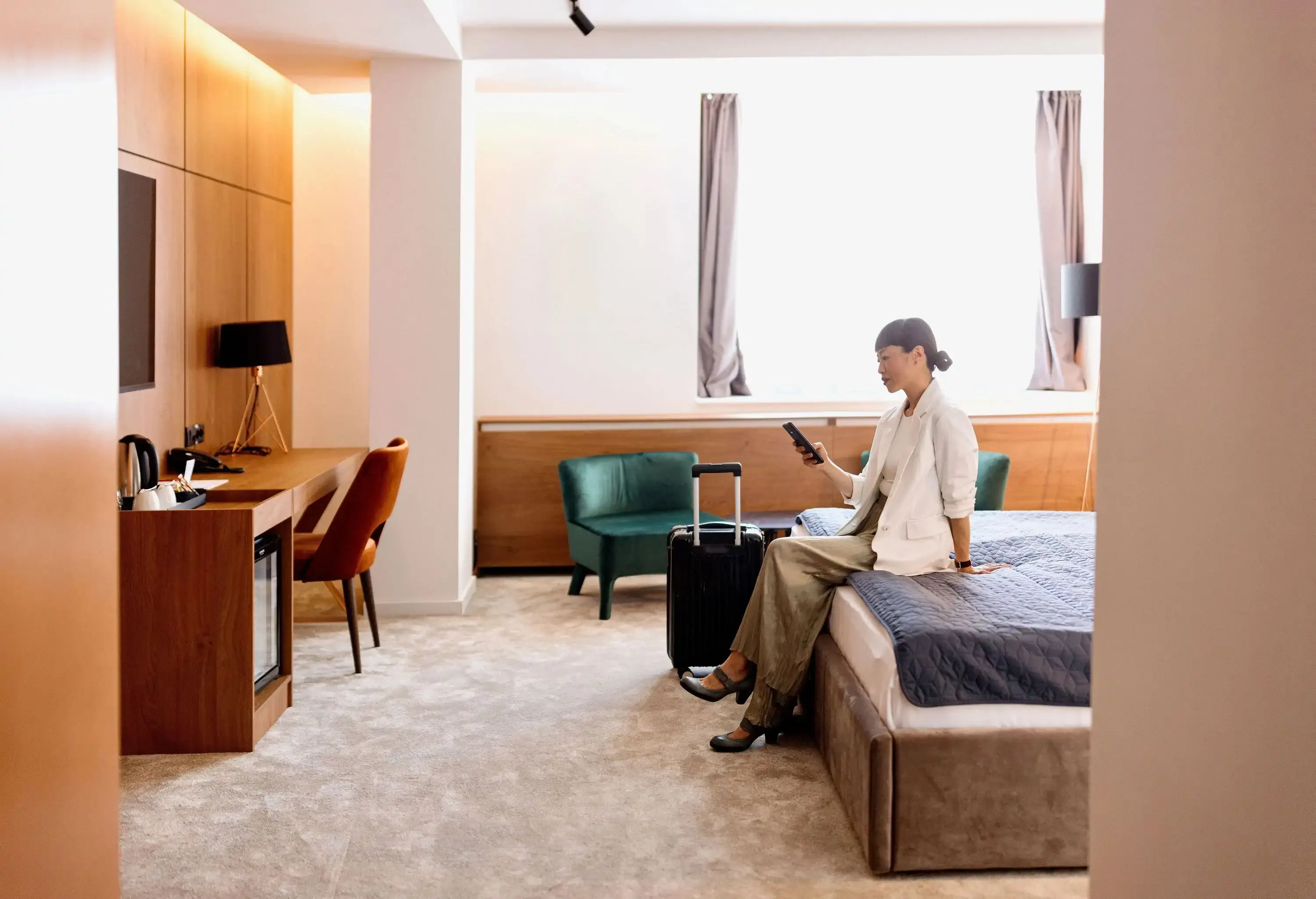 Productive businesswoman taking a break at a hotel room