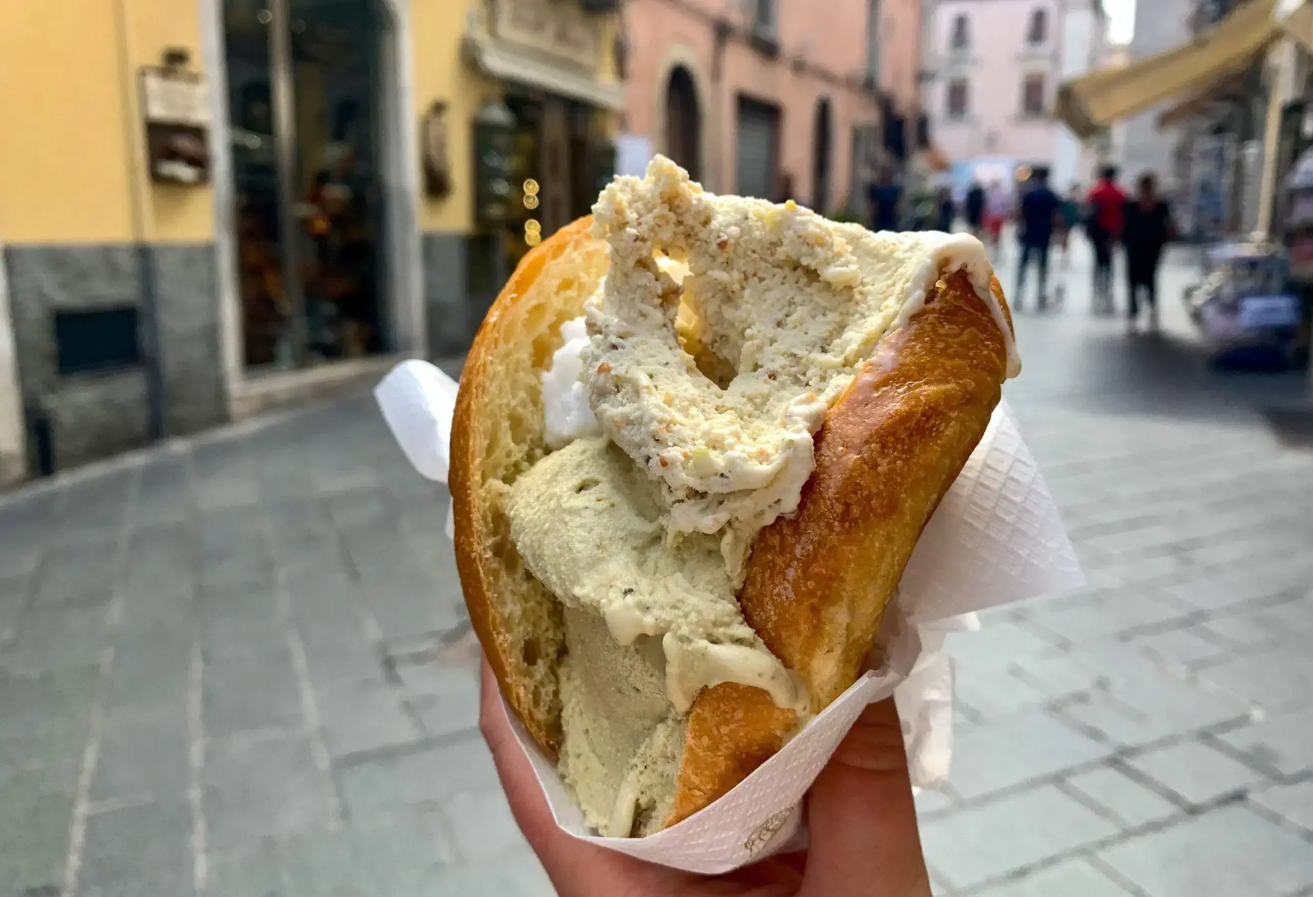 An ice cream sandwich wrapped in tissue paper.