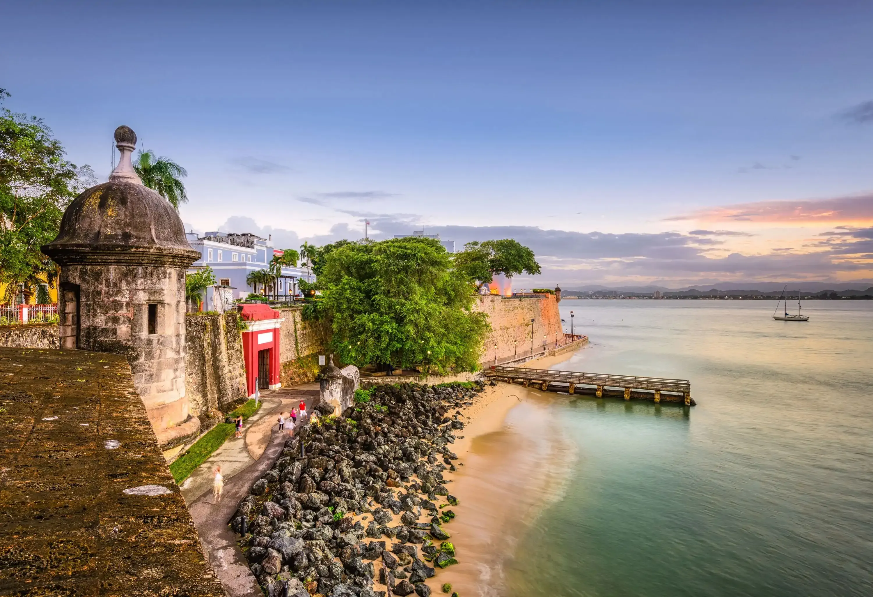 A town on the coast with an ancient fortification and rugged shoreline keeping the sea at bay.