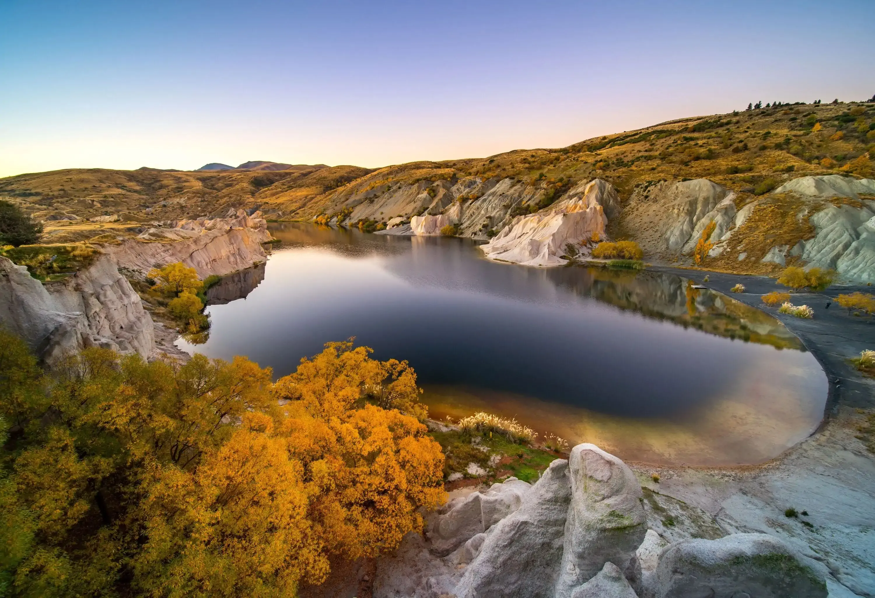 Tranquil sunrise by a blue lake surrounded by mountains