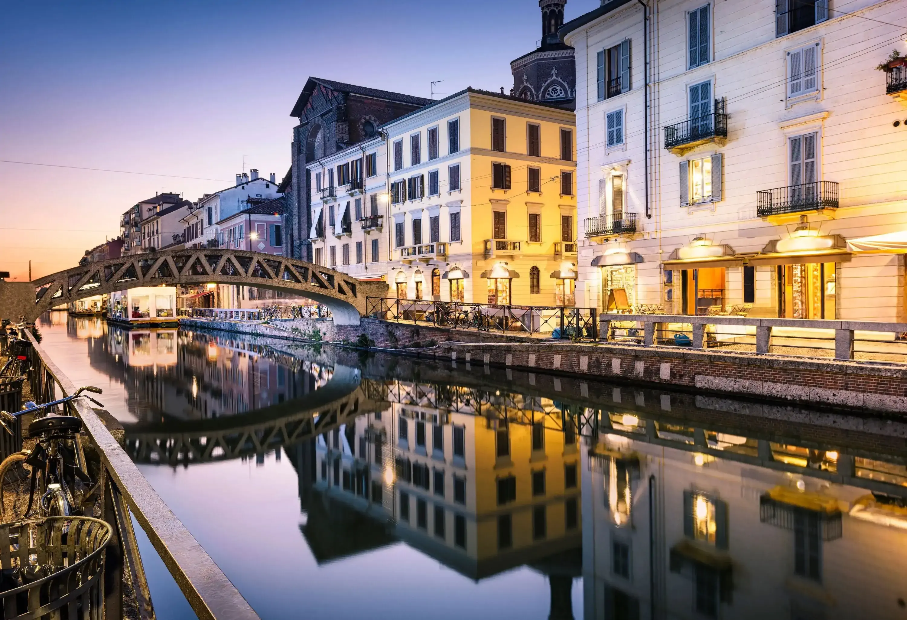 Bridge across the Naviglio Grande canal at the evening in Milan, Italy