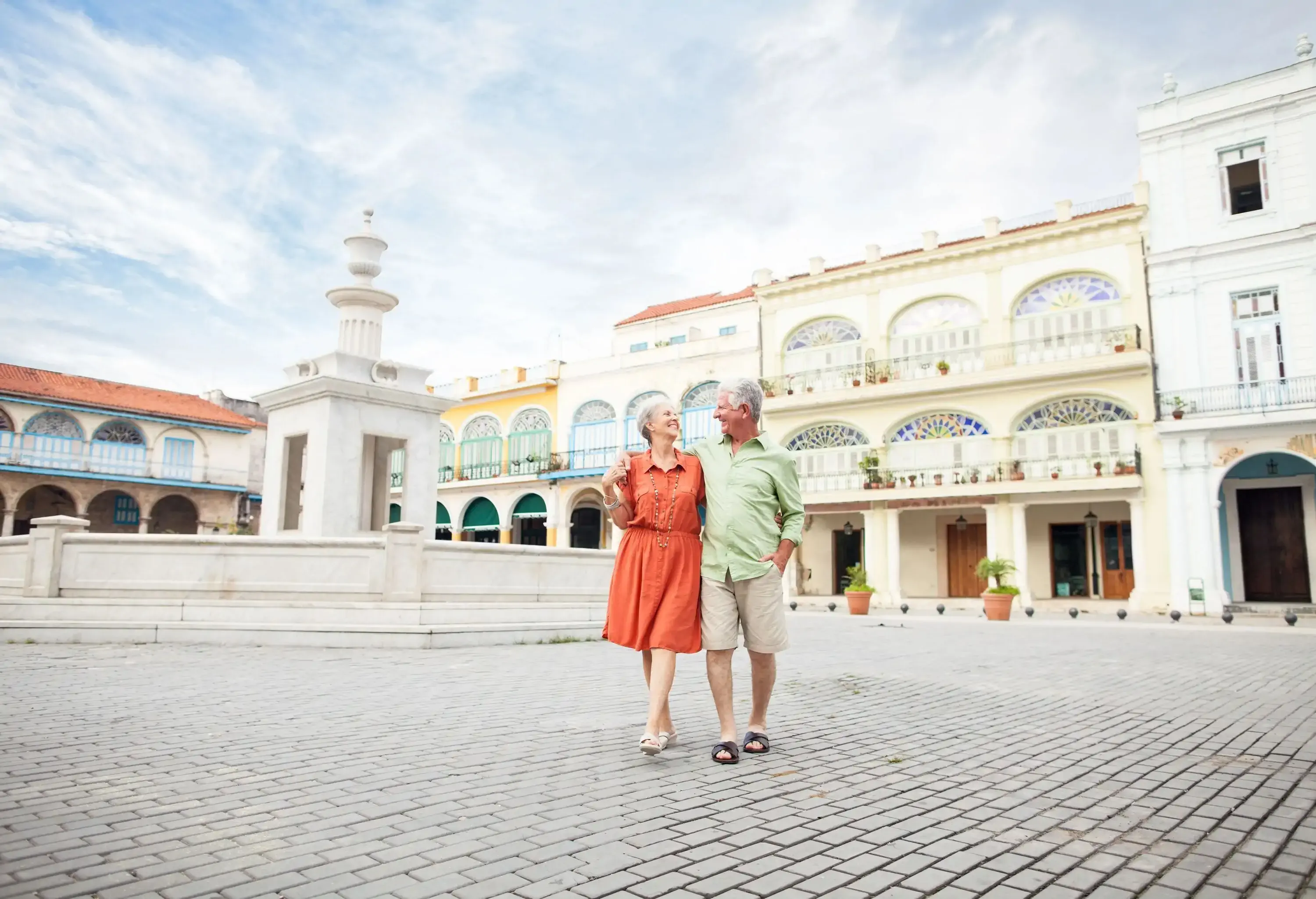 Loving elderly couple walking on the town square